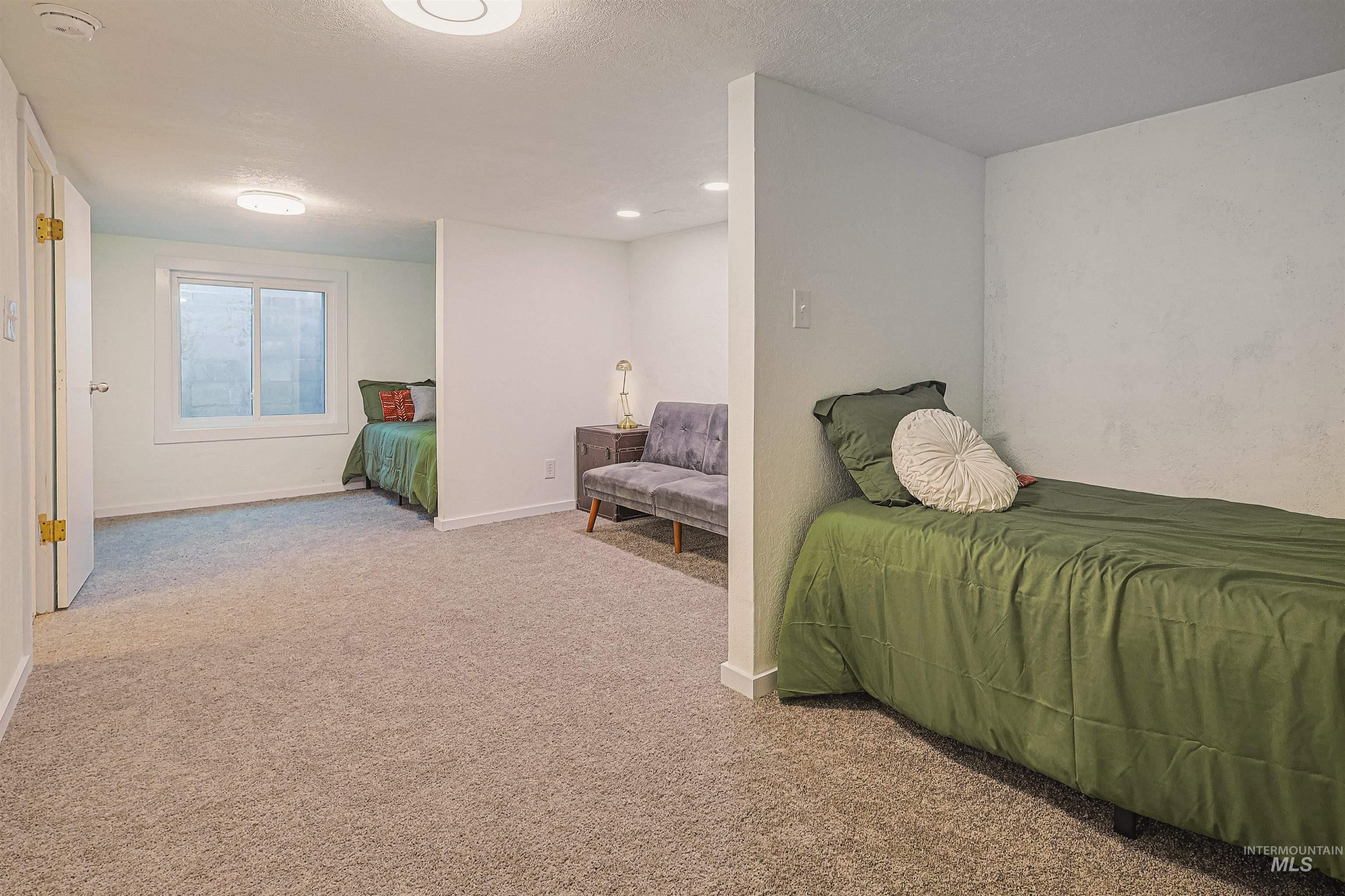 Sitting room featuring a textured ceiling and wood finished floors