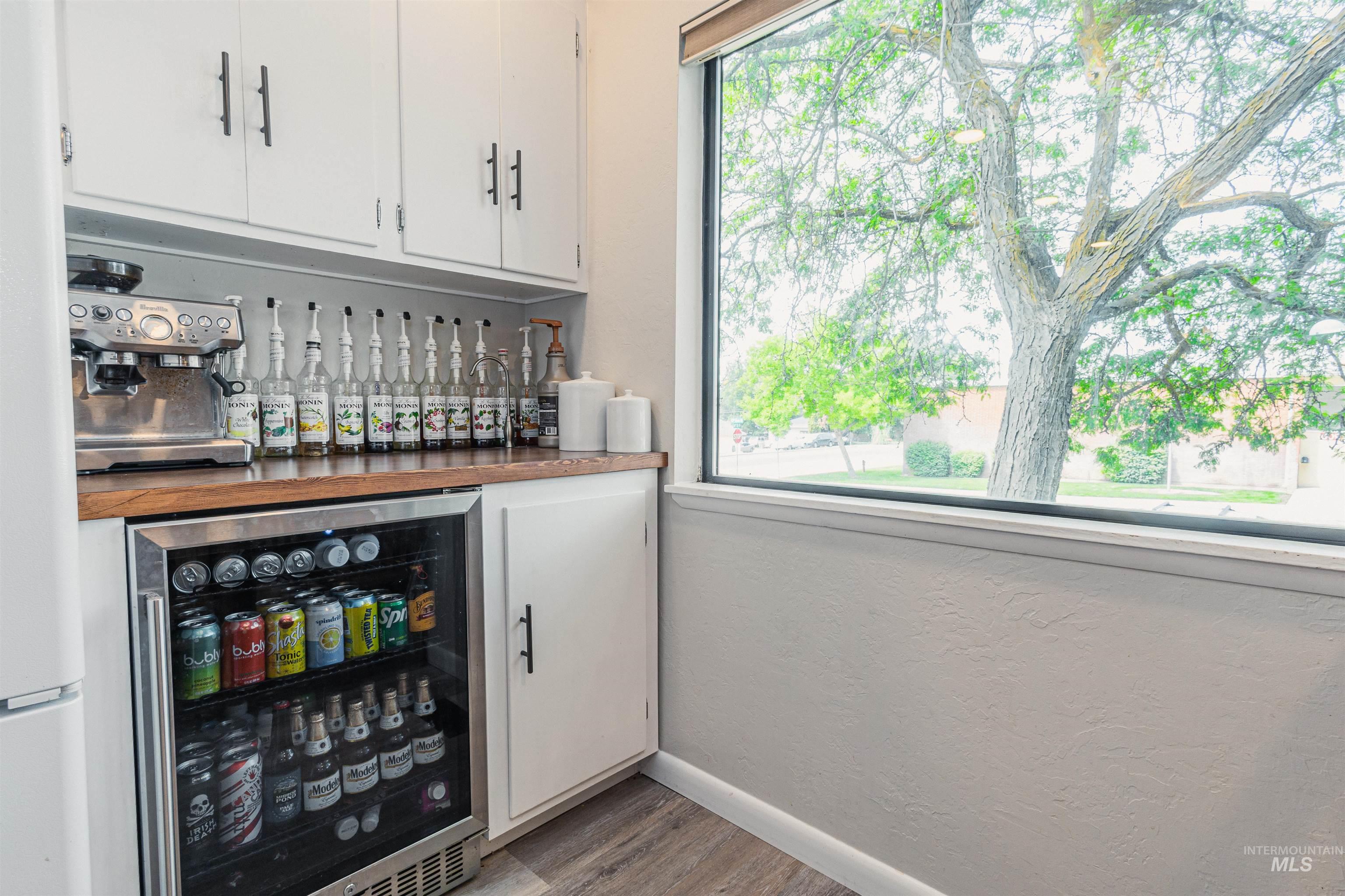 Kitchen featuring dark countertops, a tray ceiling, open shelves, black electric range oven, and recessed lighting