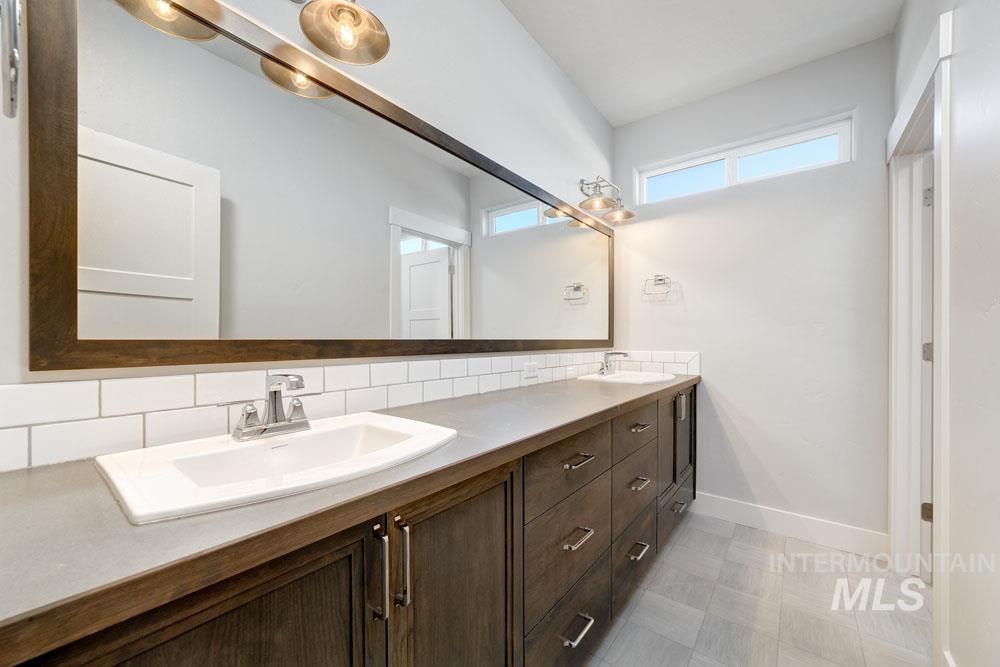 Bathroom with tasteful backsplash and double vanity