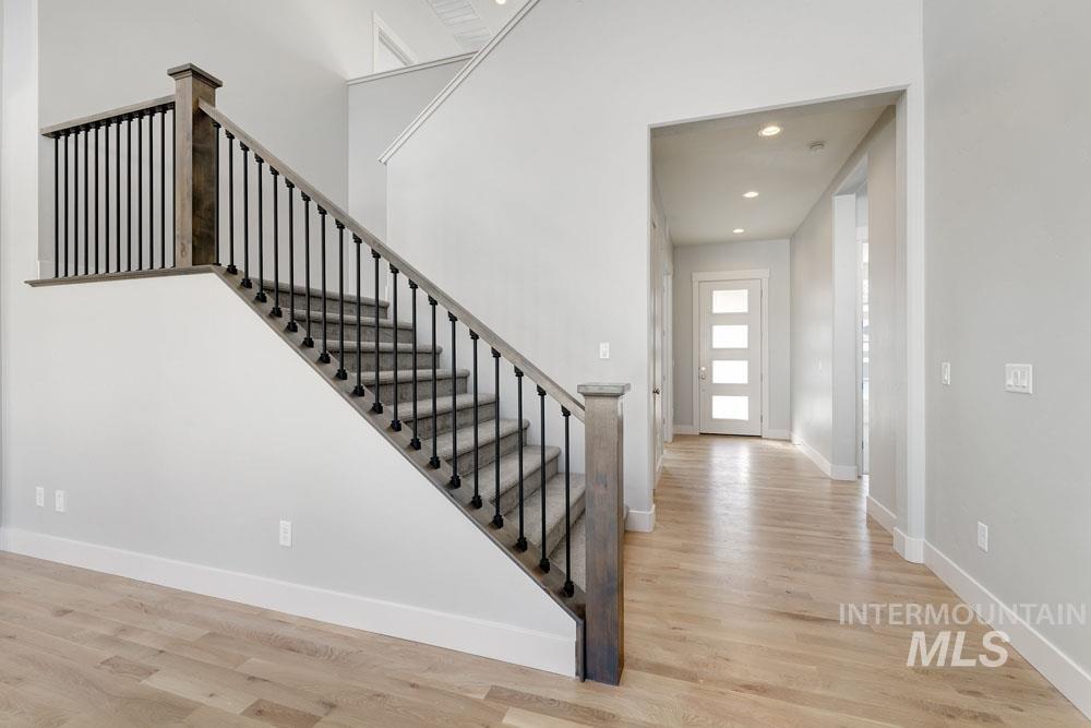 Stairway featuring recessed lighting and wood finished floors