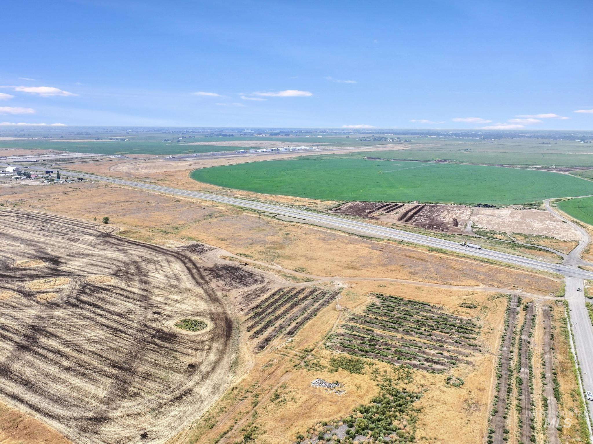 Aerial overview of property's location featuring rural landscape and farmland