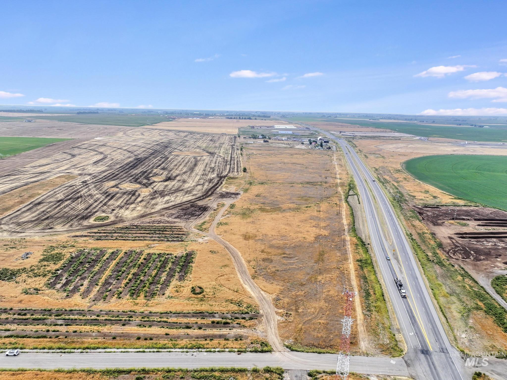 Aerial view of sparsely populated area featuring rows of crops