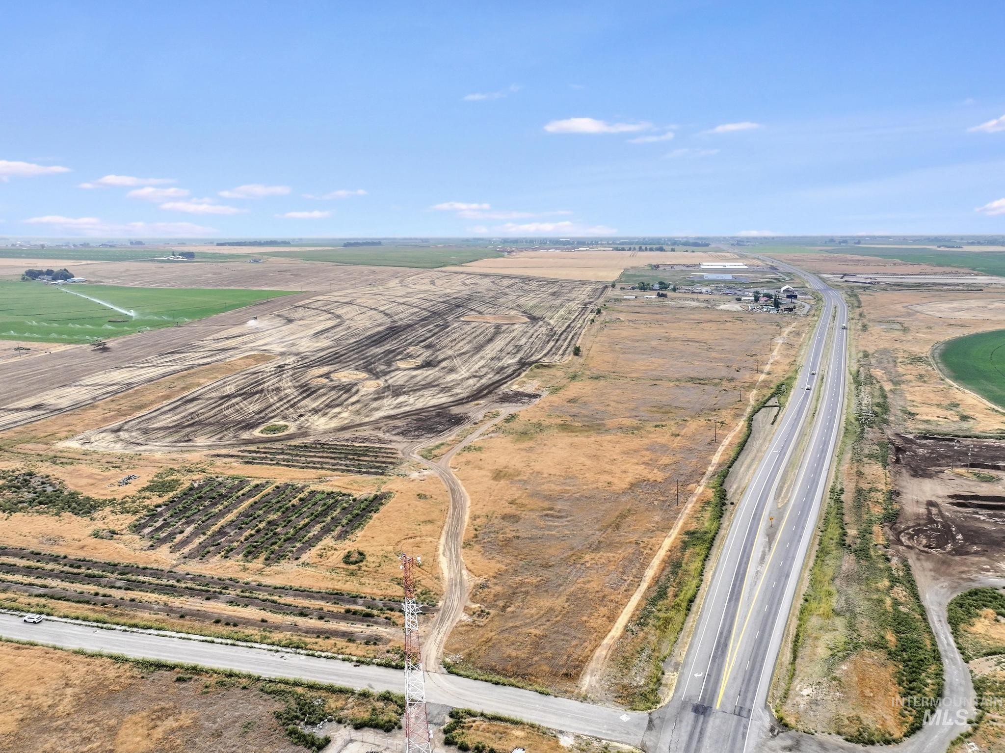 Aerial view of property's location featuring rural landscape and farmland
