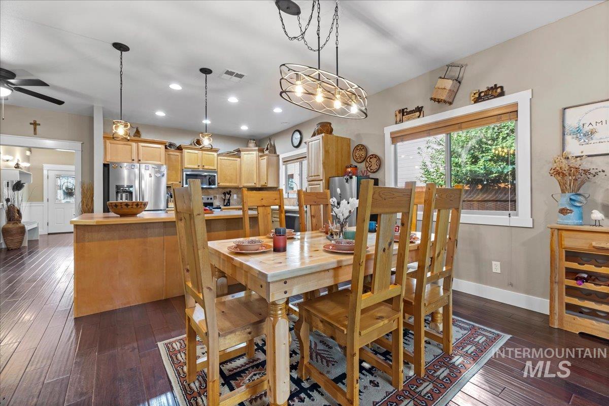 Dining space with recessed lighting, dark wood-style floors, and a ceiling fan