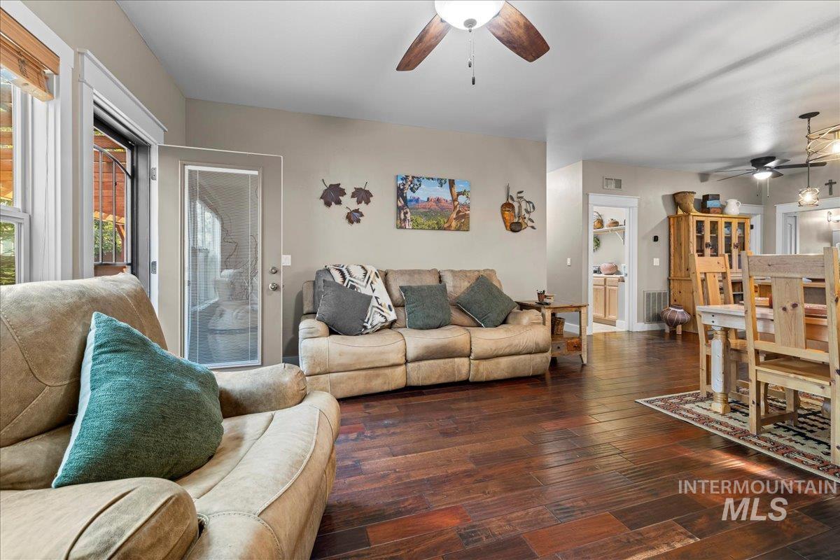 Living room featuring a ceiling fan and hardwood / wood-style floors