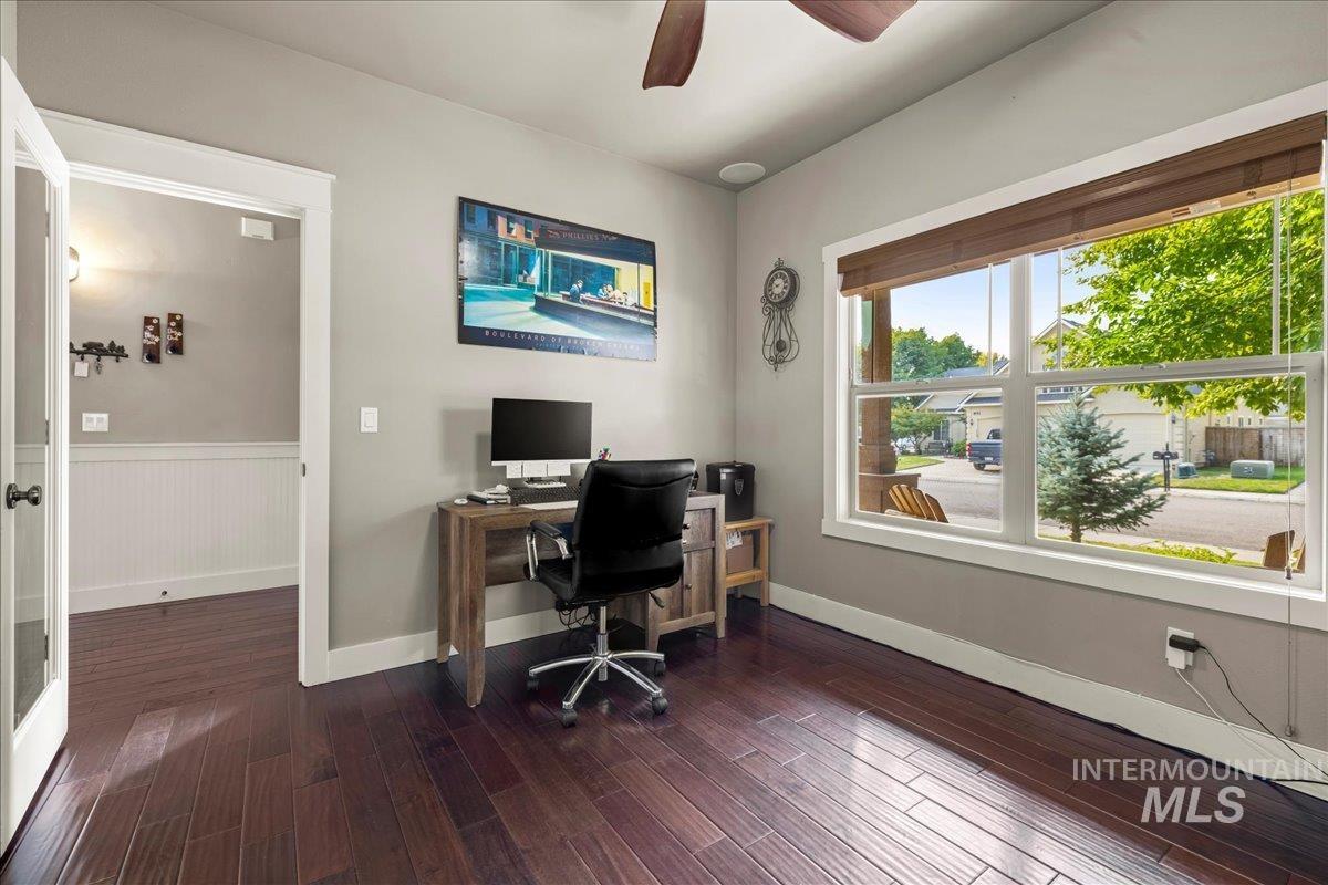 Office space with ceiling fan and dark wood-style flooring