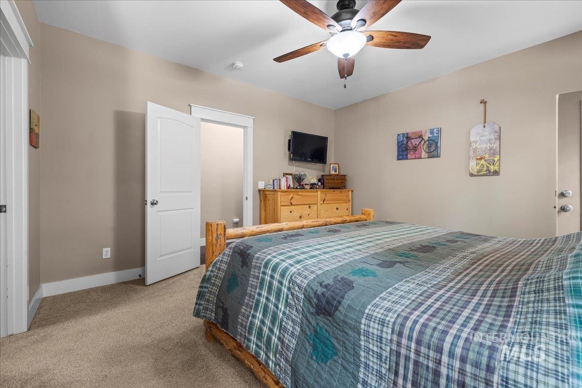 Bedroom with carpet and a ceiling fan
