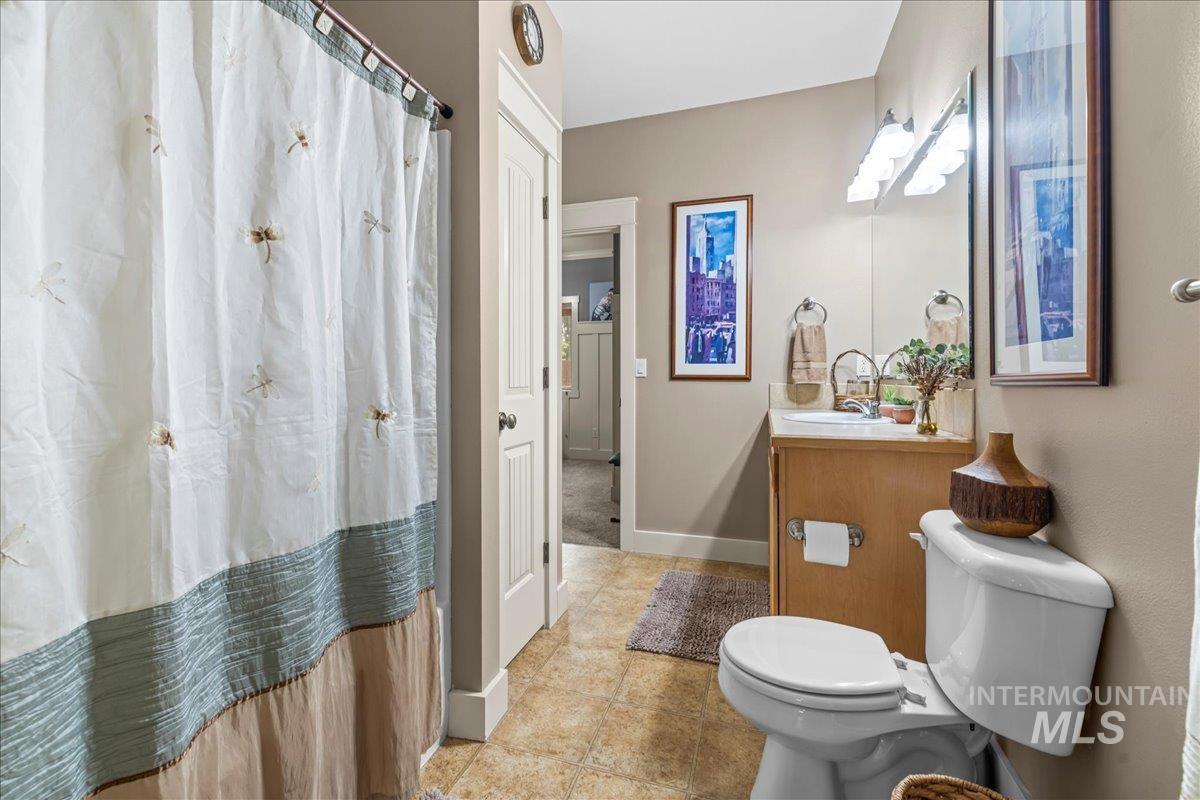Full bath with vanity and a shower with shower curtain