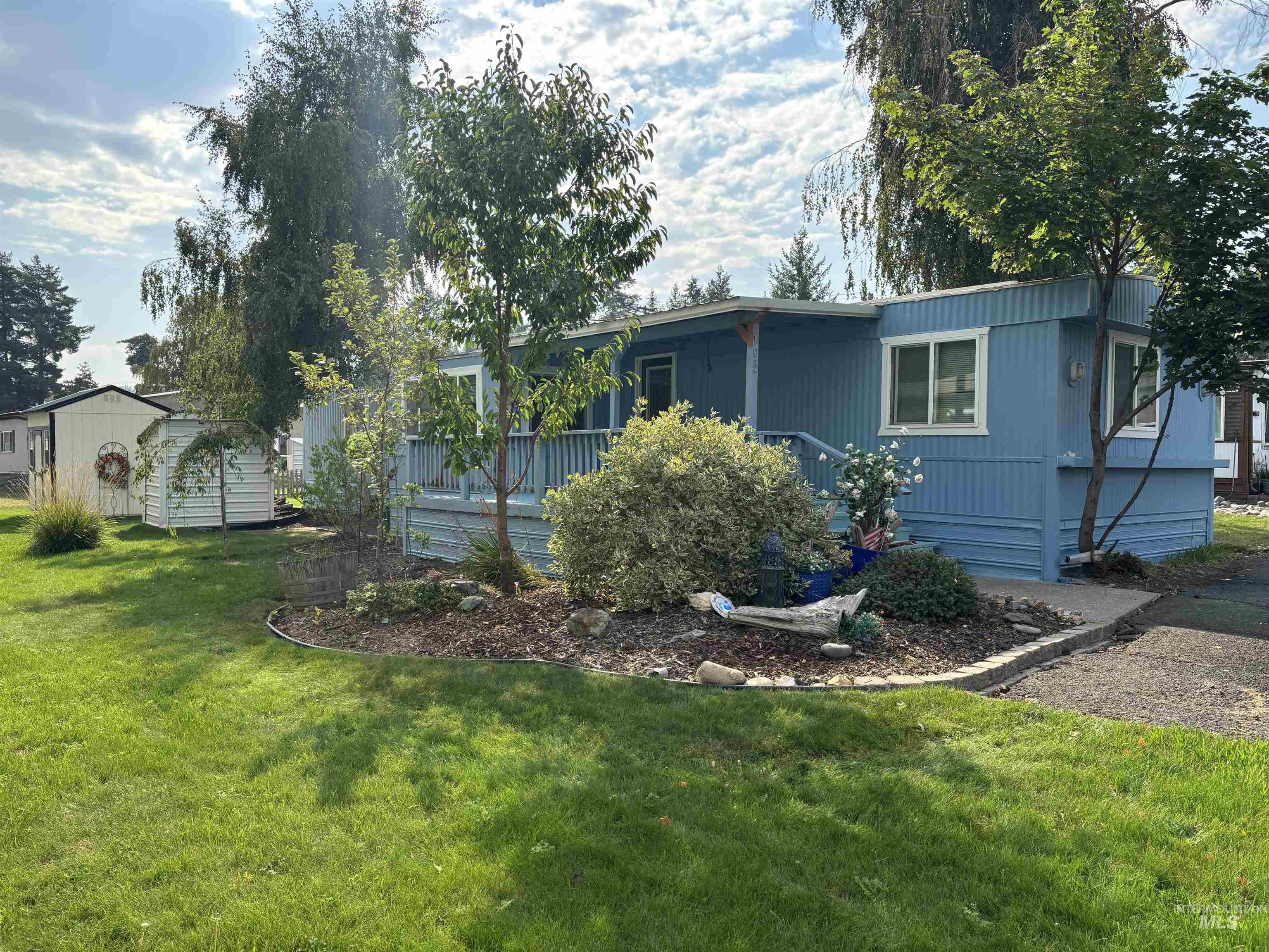 View of front of home with a front yard and an outdoor structure