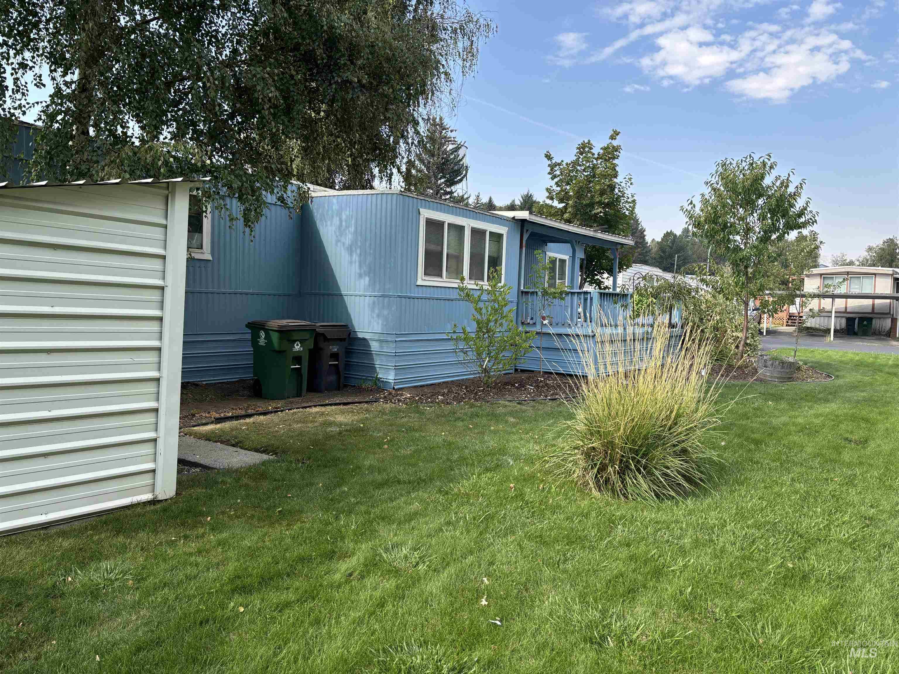 Rear view of house featuring a yard and a wooden deck