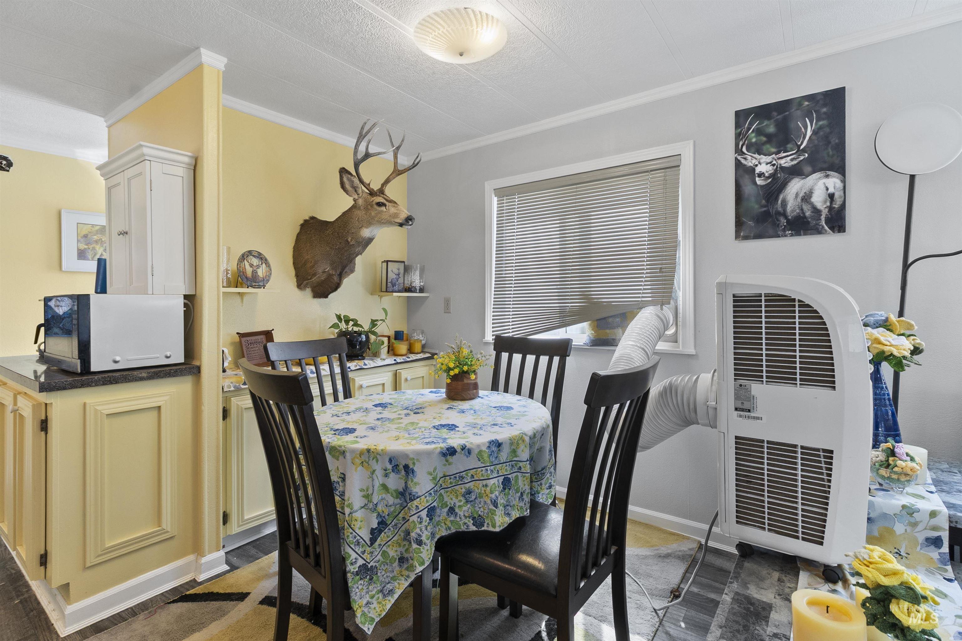 Dining room with ornamental molding and heating unit