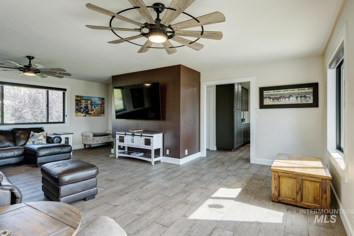 Living area with ceiling fans and tiled floors