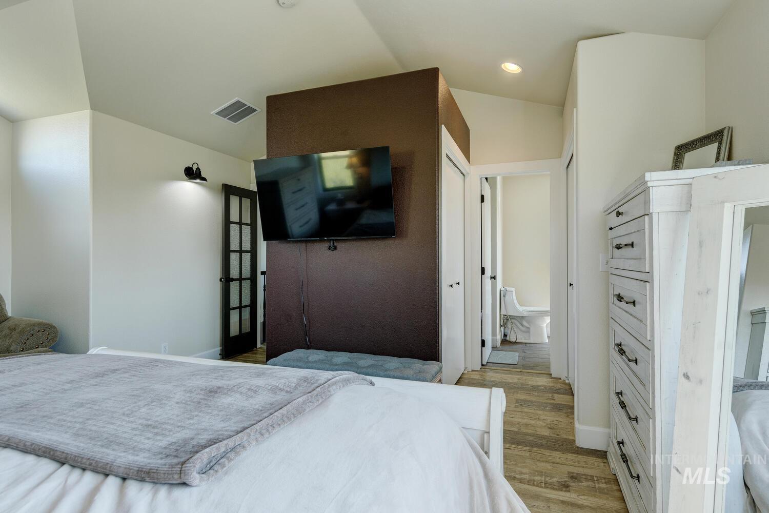 Bedroom with LVP and recessed lighting
