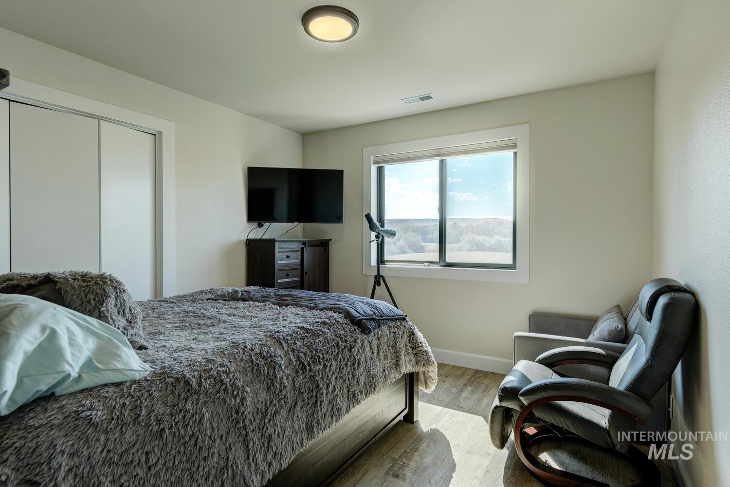 Bedroom featuring LVP floors and a closet
