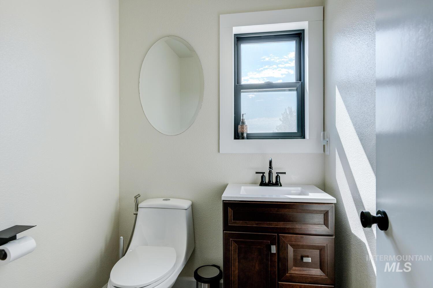 Half bath with vanity and toilet