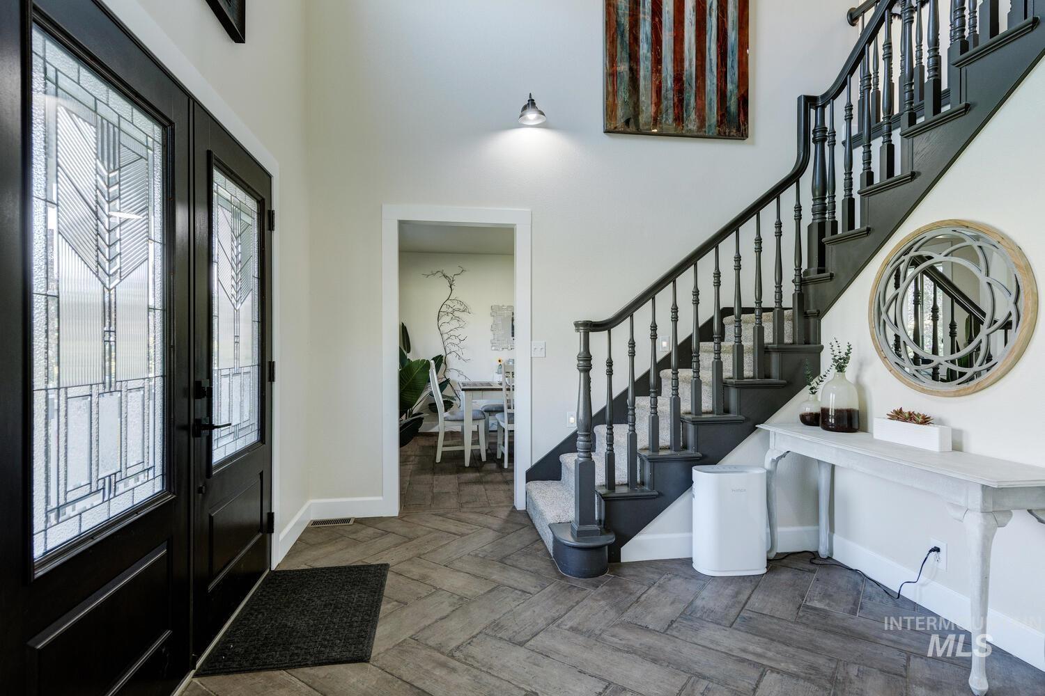 Foyer with stairway and a high ceiling