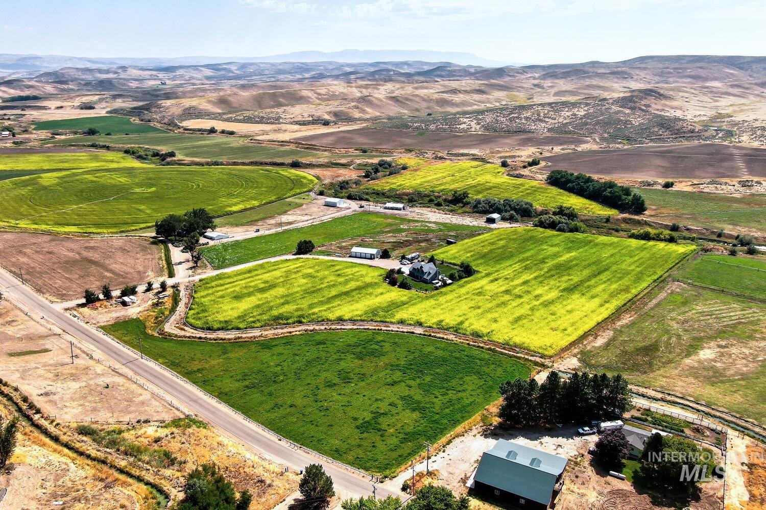 Aerial view of property and surrounding area featuring rural landscape