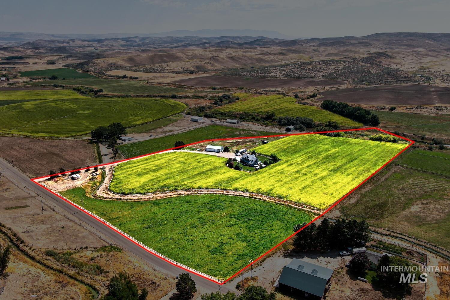 Overview of rural landscape with property approximate boundaries highlighted and mountains