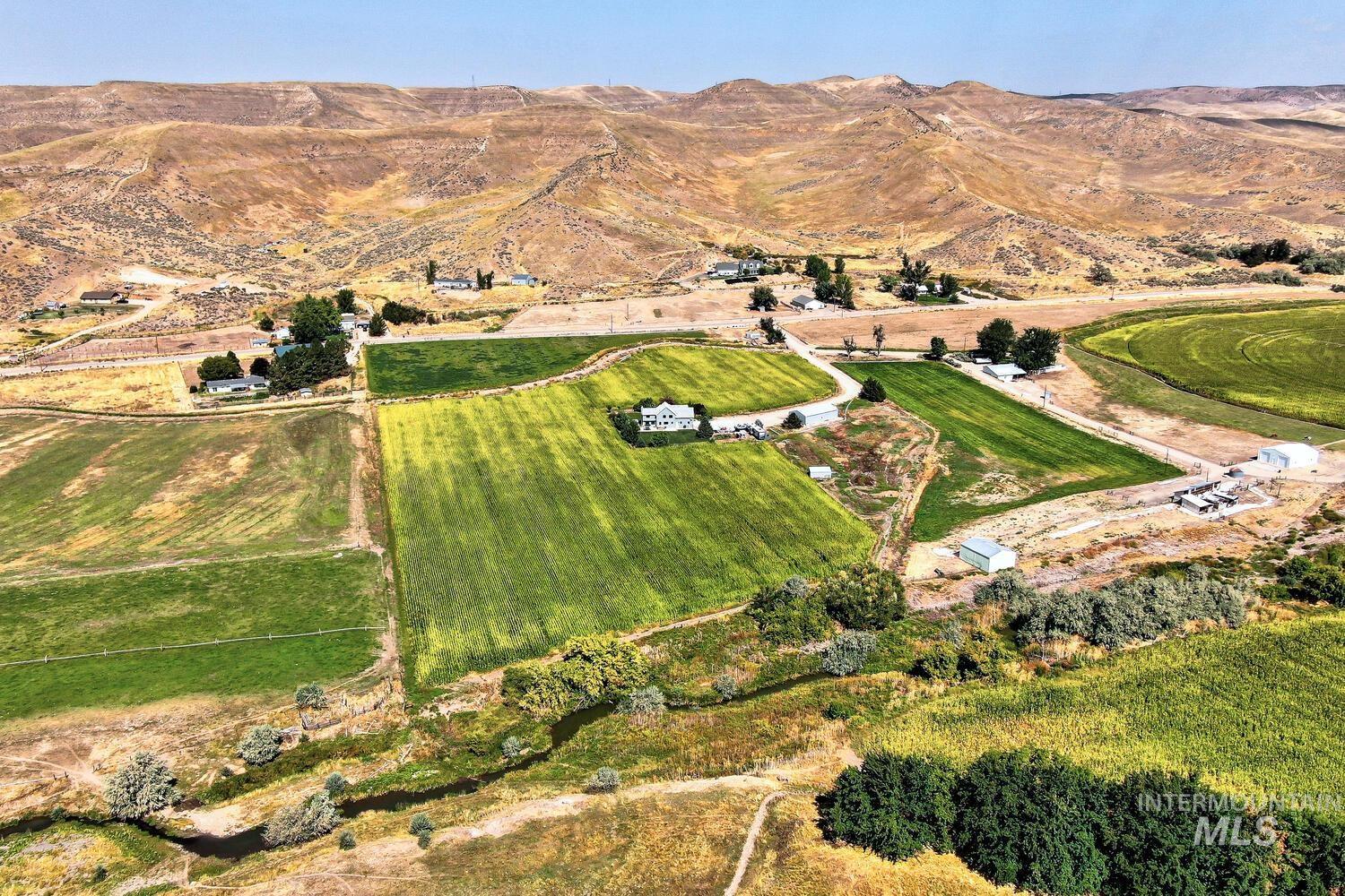 Aerial overview of property's location with rural landscape and mountains