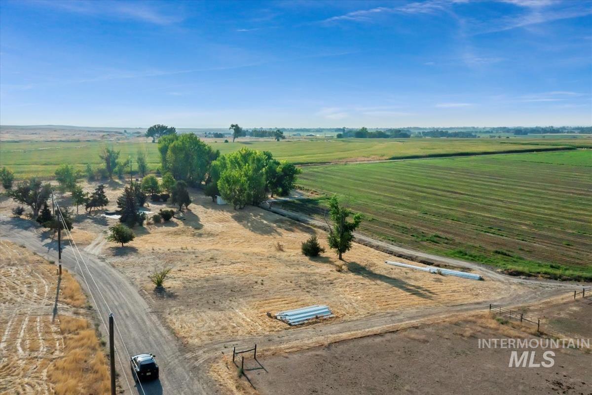 Aerial view of property and surrounding area featuring rural landscape