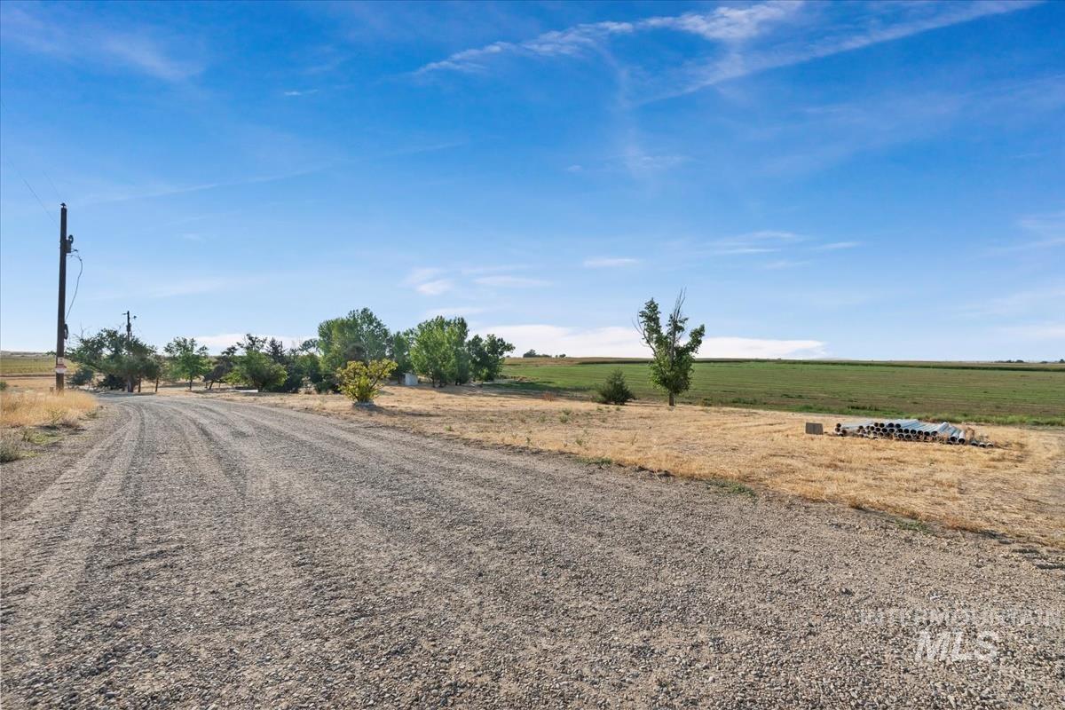 View of dirt / gravel road featuring a rural view