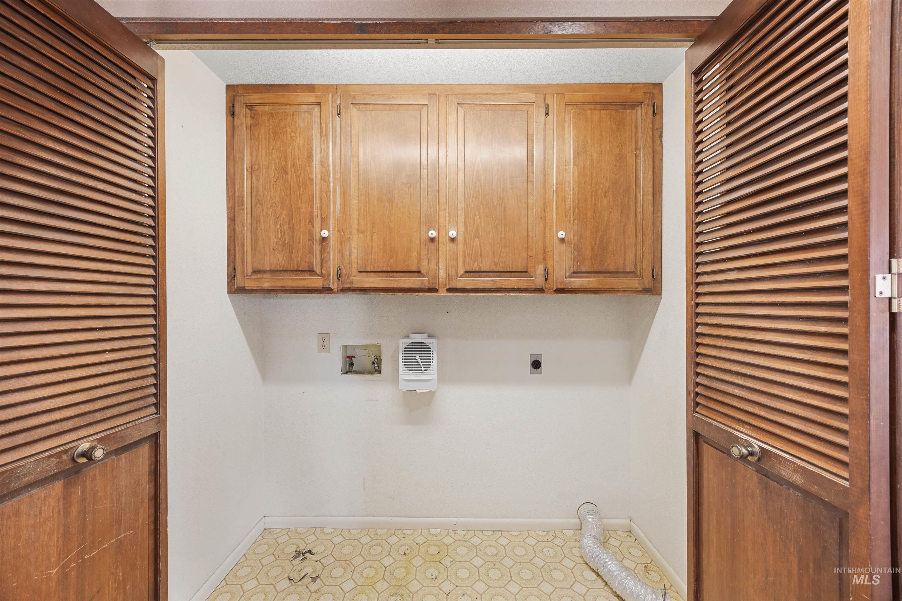 Laundry room with cabinet space, hookup for a washing machine, and hookup for an electric dryer