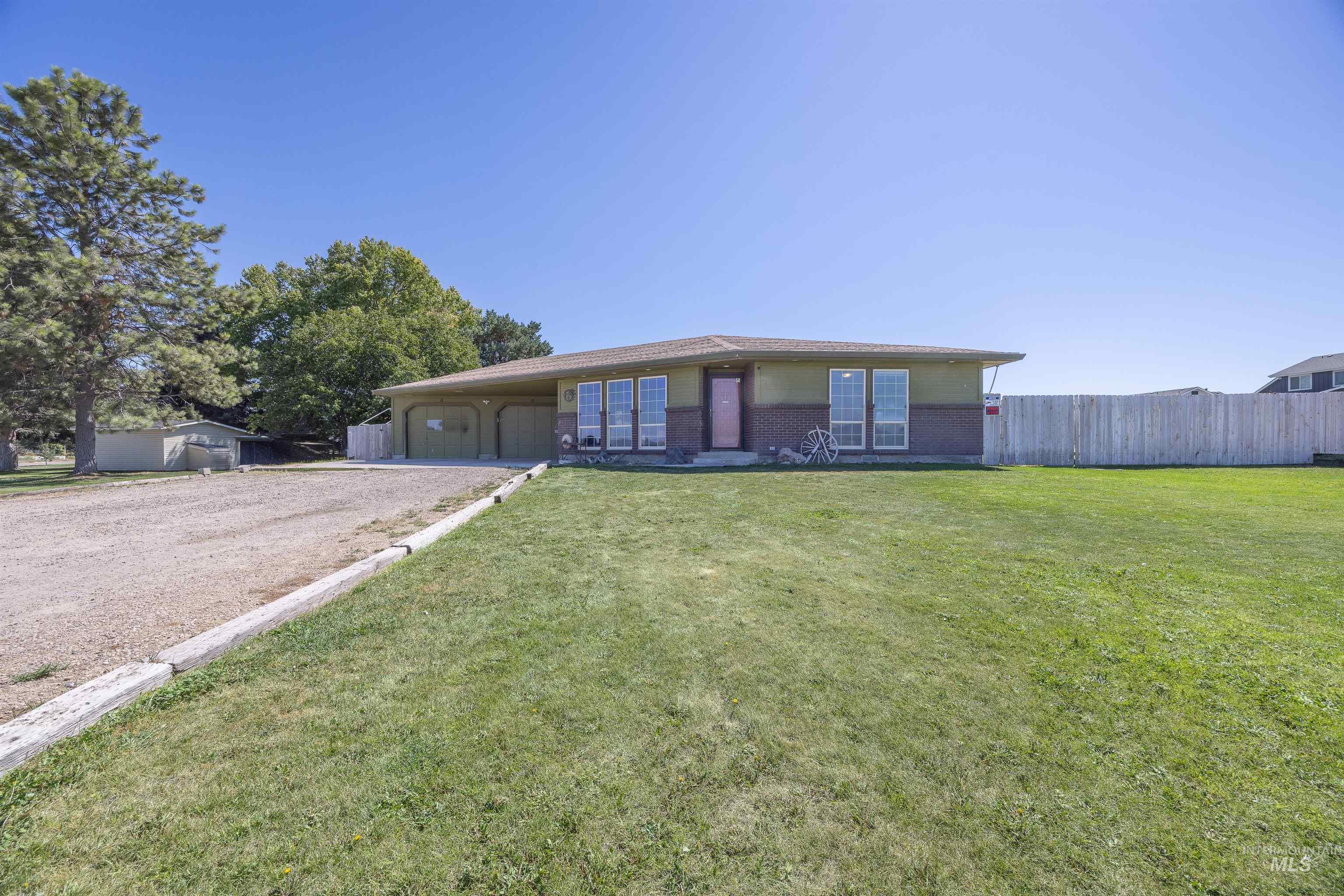 View of front of home featuring brick siding and driveway