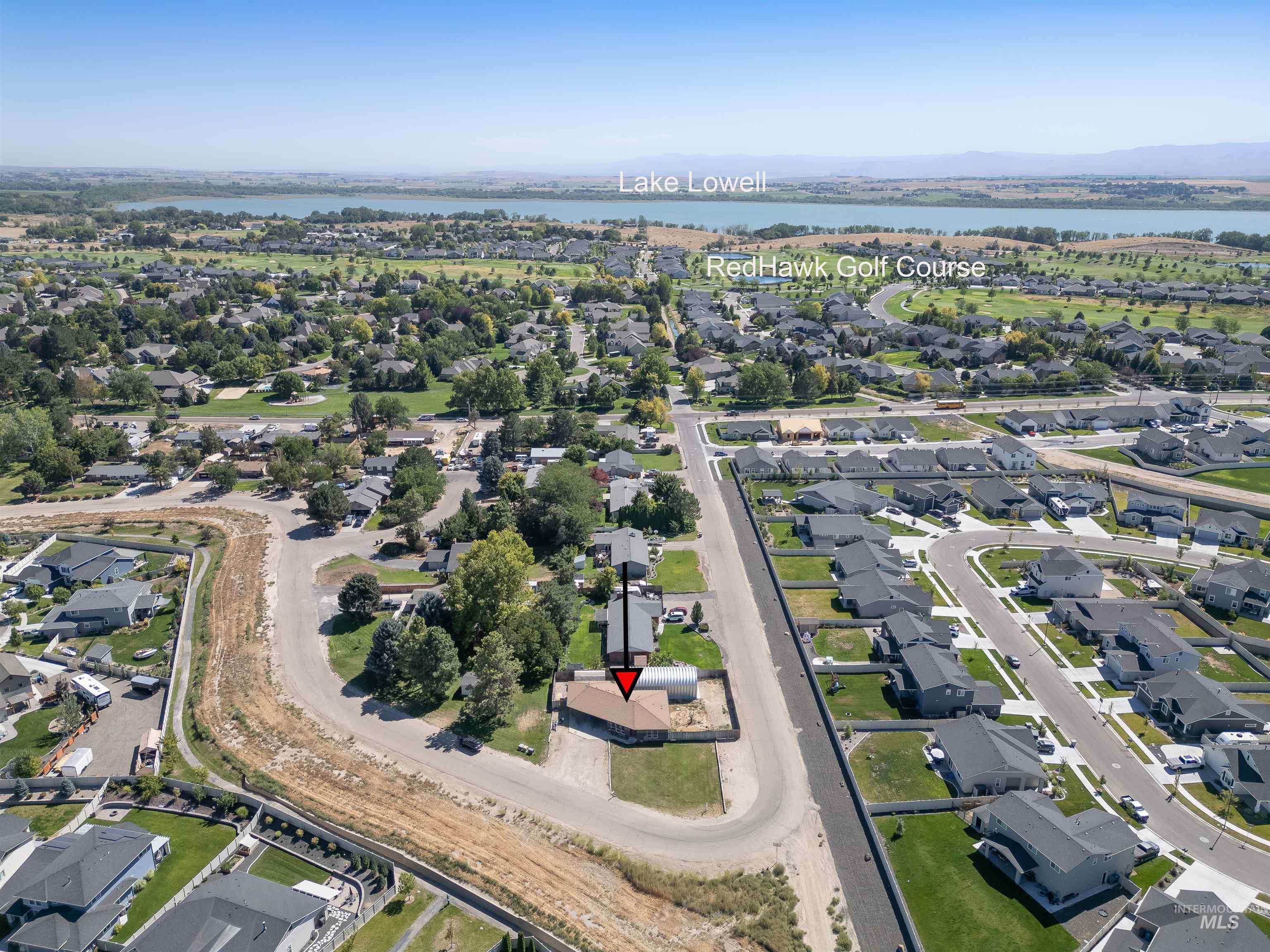 View of property location featuring nearby suburban area and a nearby body of water