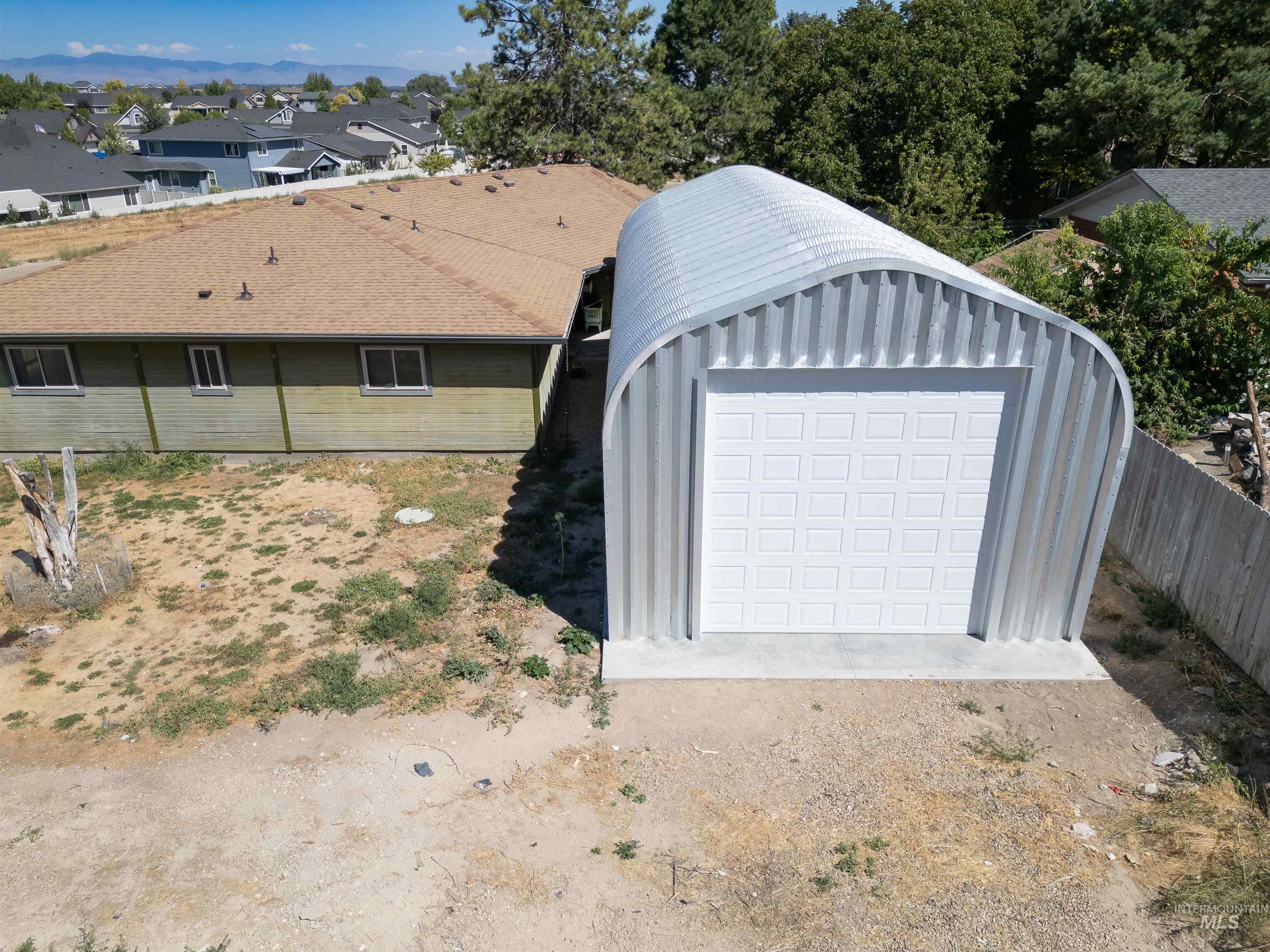 View of outbuilding featuring dirt driveway