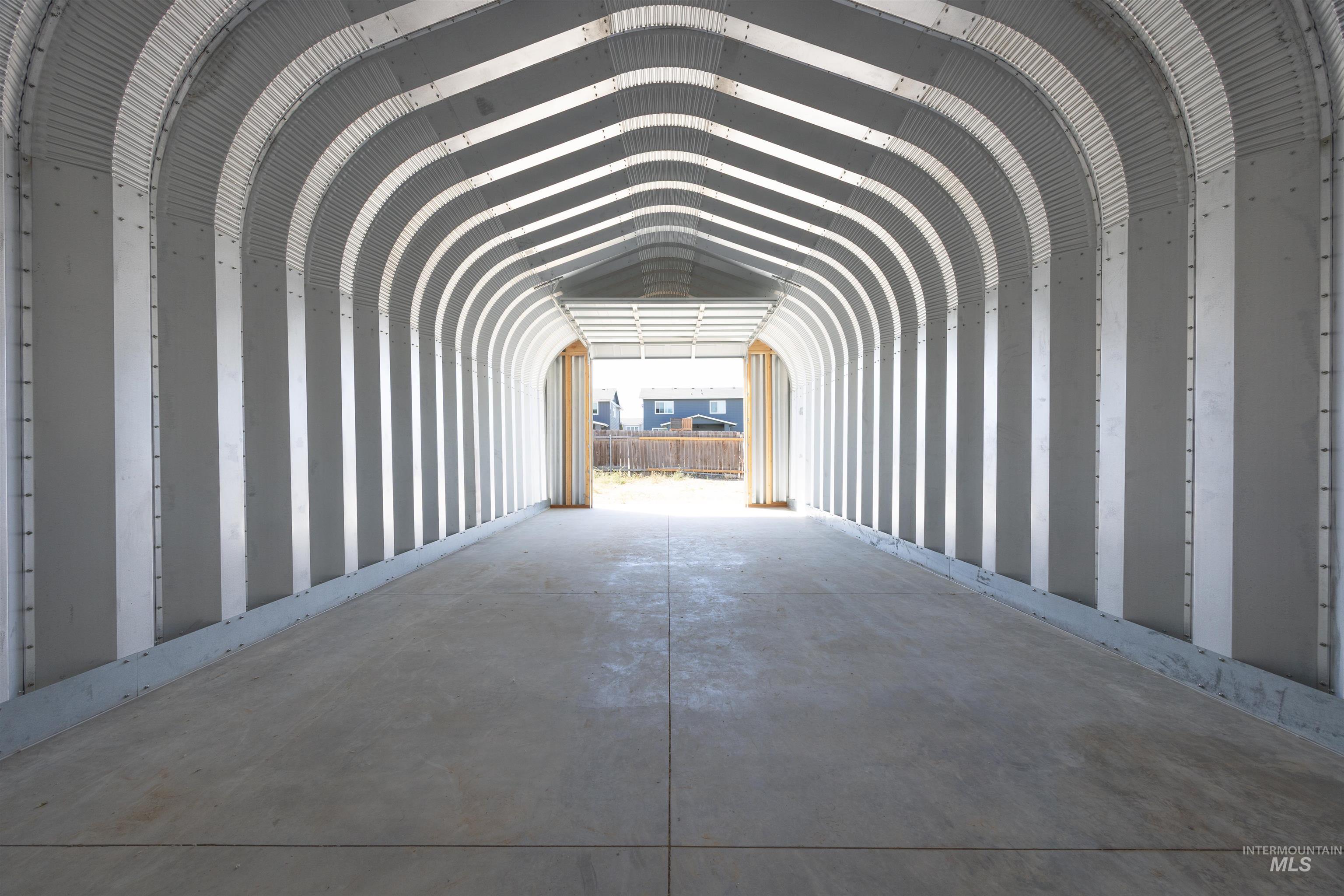 Misc room with unfinished concrete flooring and a garage