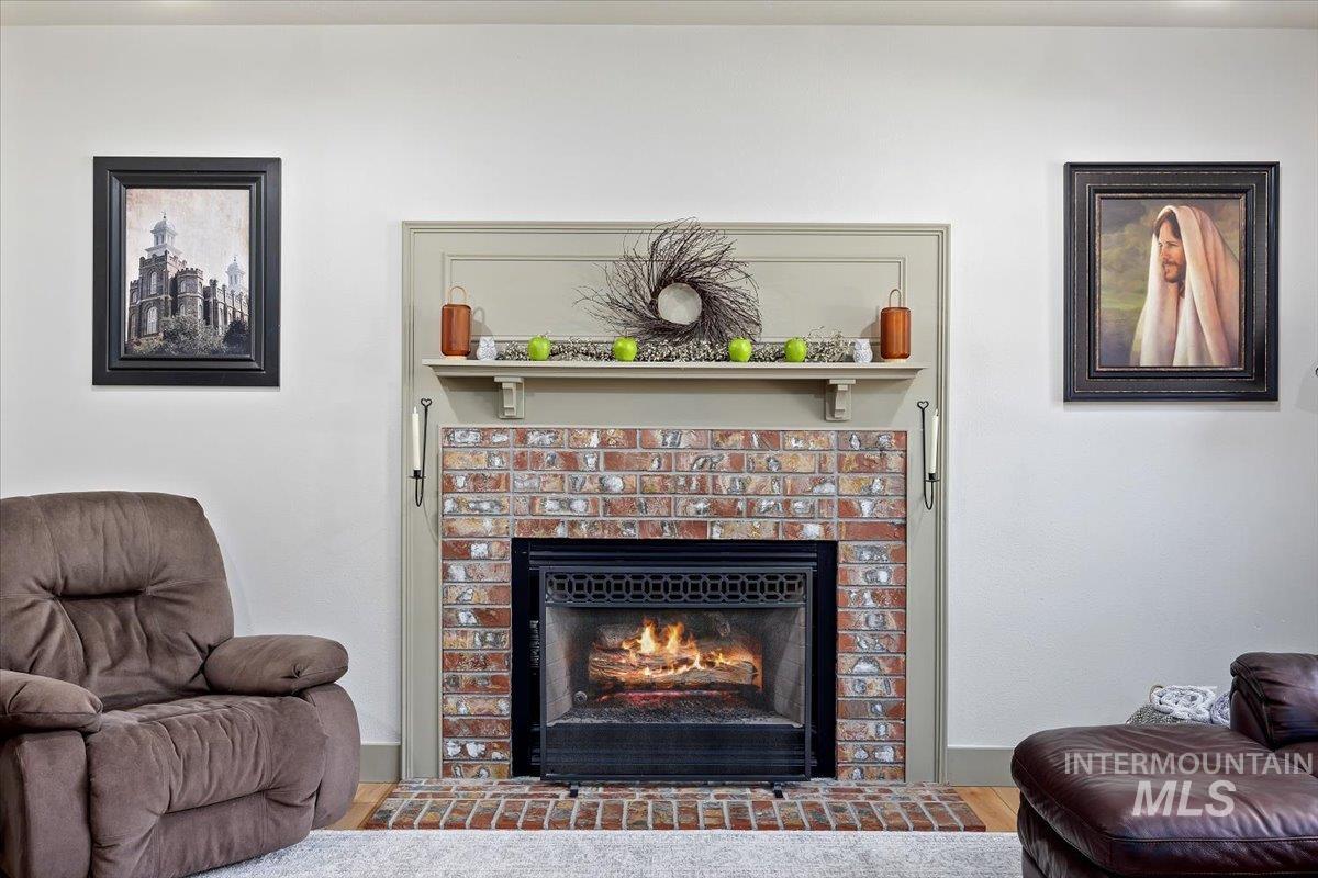 Living room featuring wood finished floors and a brick fireplace