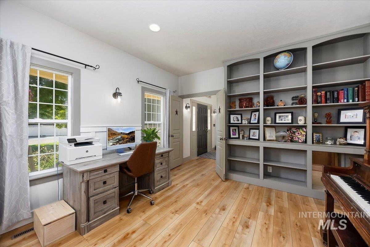 Office area with light wood-style floors