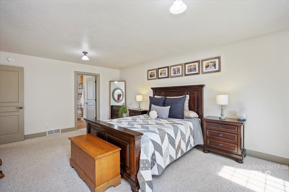 Carpeted bedroom featuring baseboards
