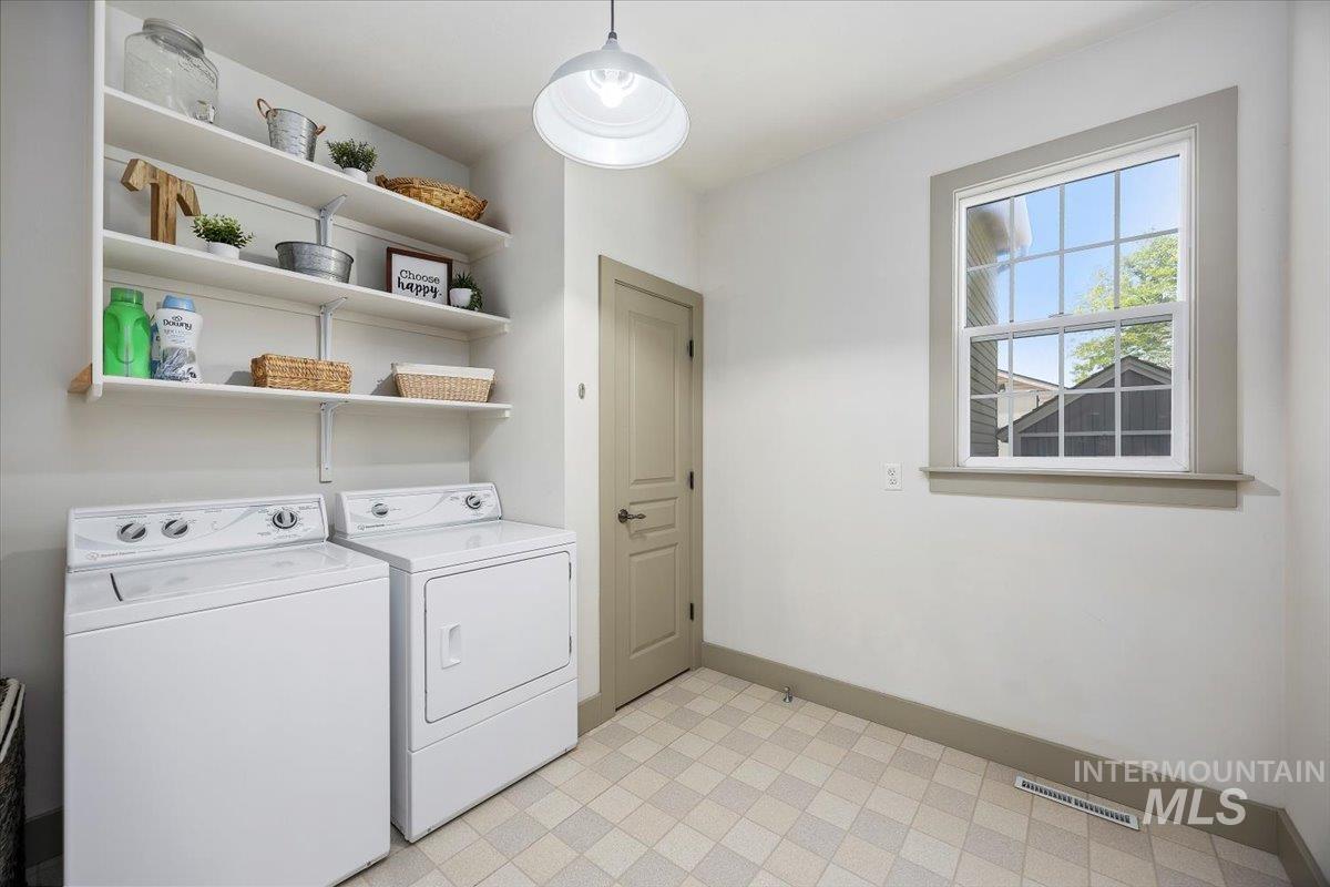 Washroom featuring washer and clothes dryer and light flooring