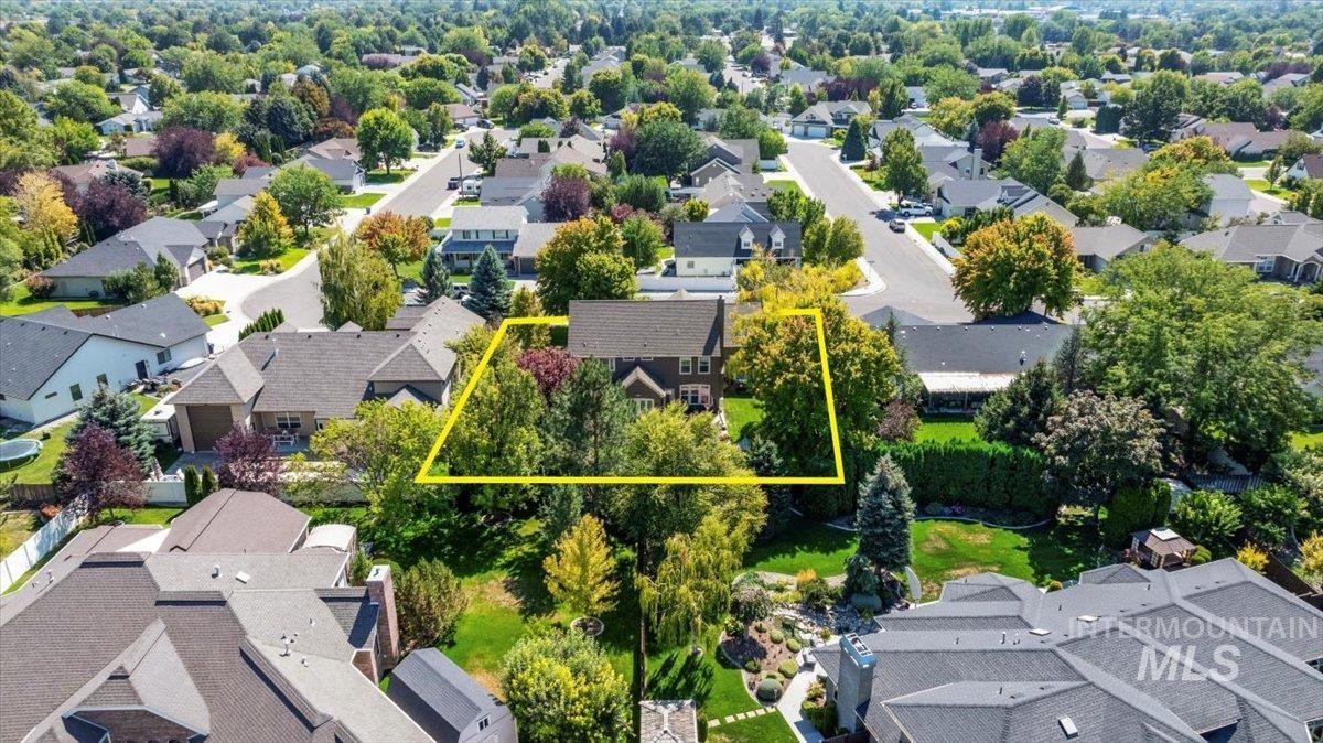 Aerial perspective of suburban area featuring property boundaries highlighted