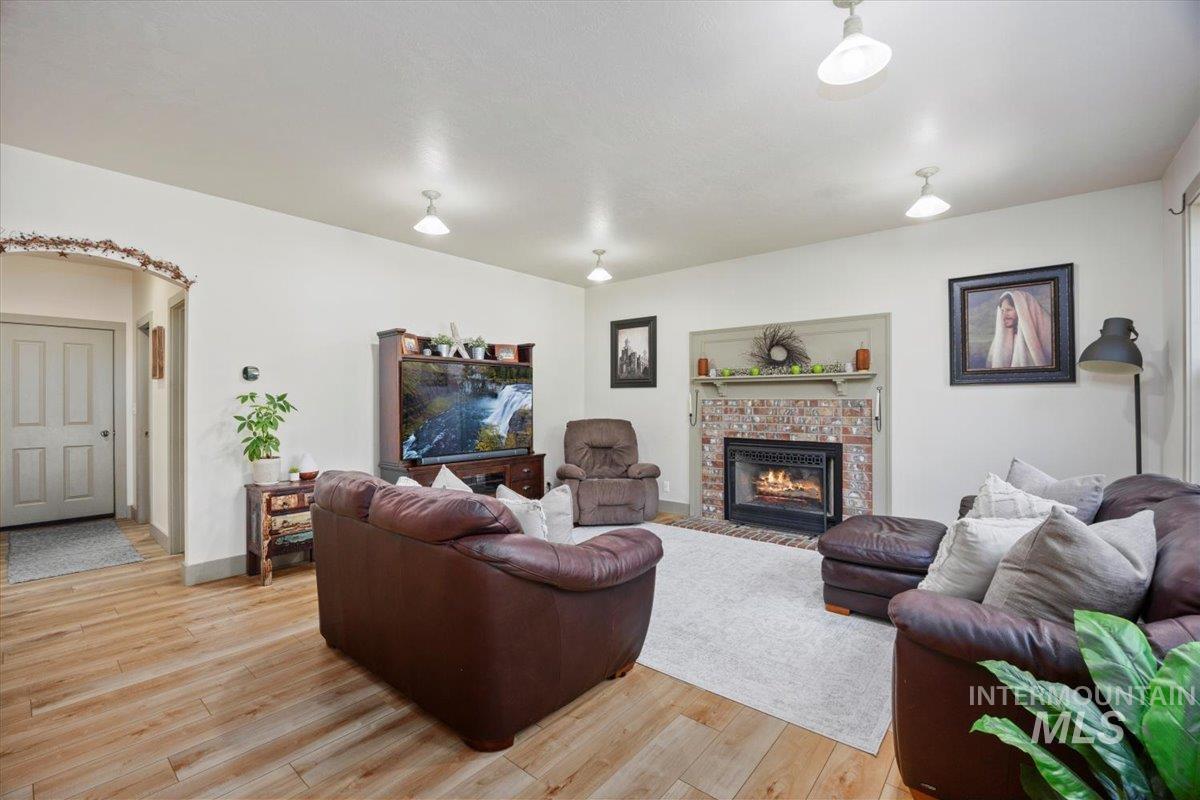 Living room featuring light wood-type flooring and a fireplace