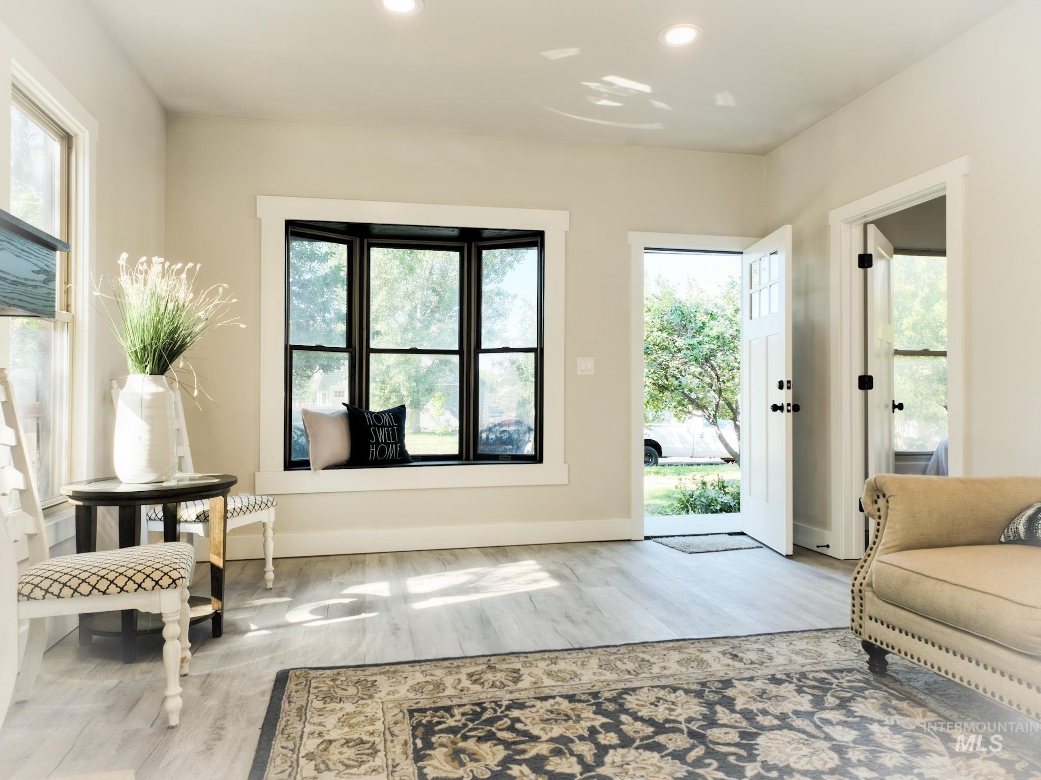 Doorway to outside featuring recessed lighting and wood finished floors