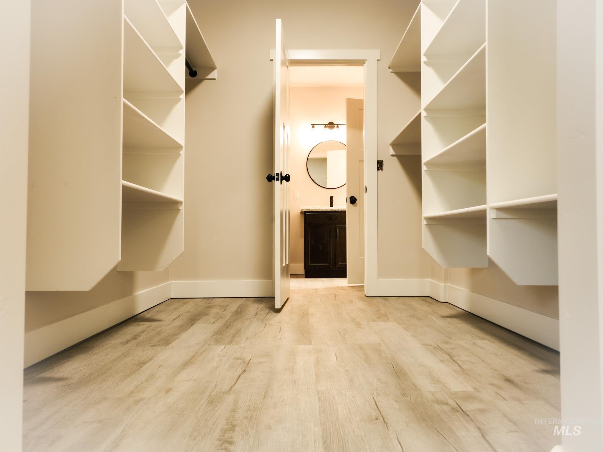 Spacious closet with light wood-style flooring