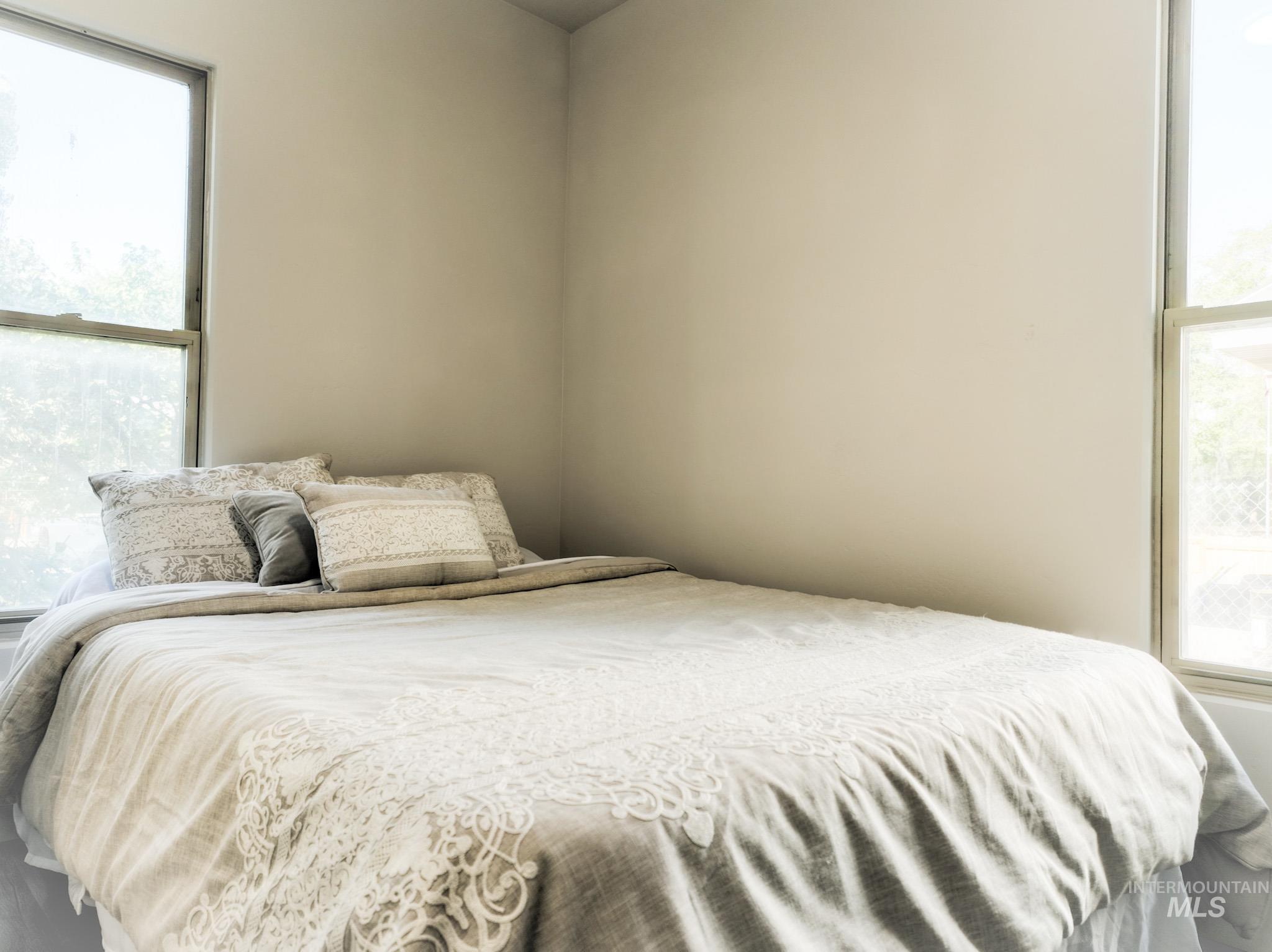 Bedroom with multiple windows