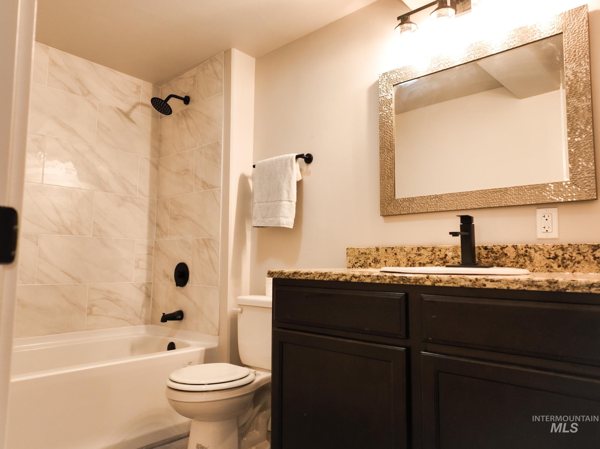 Bathroom featuring shower / washtub combination and vanity