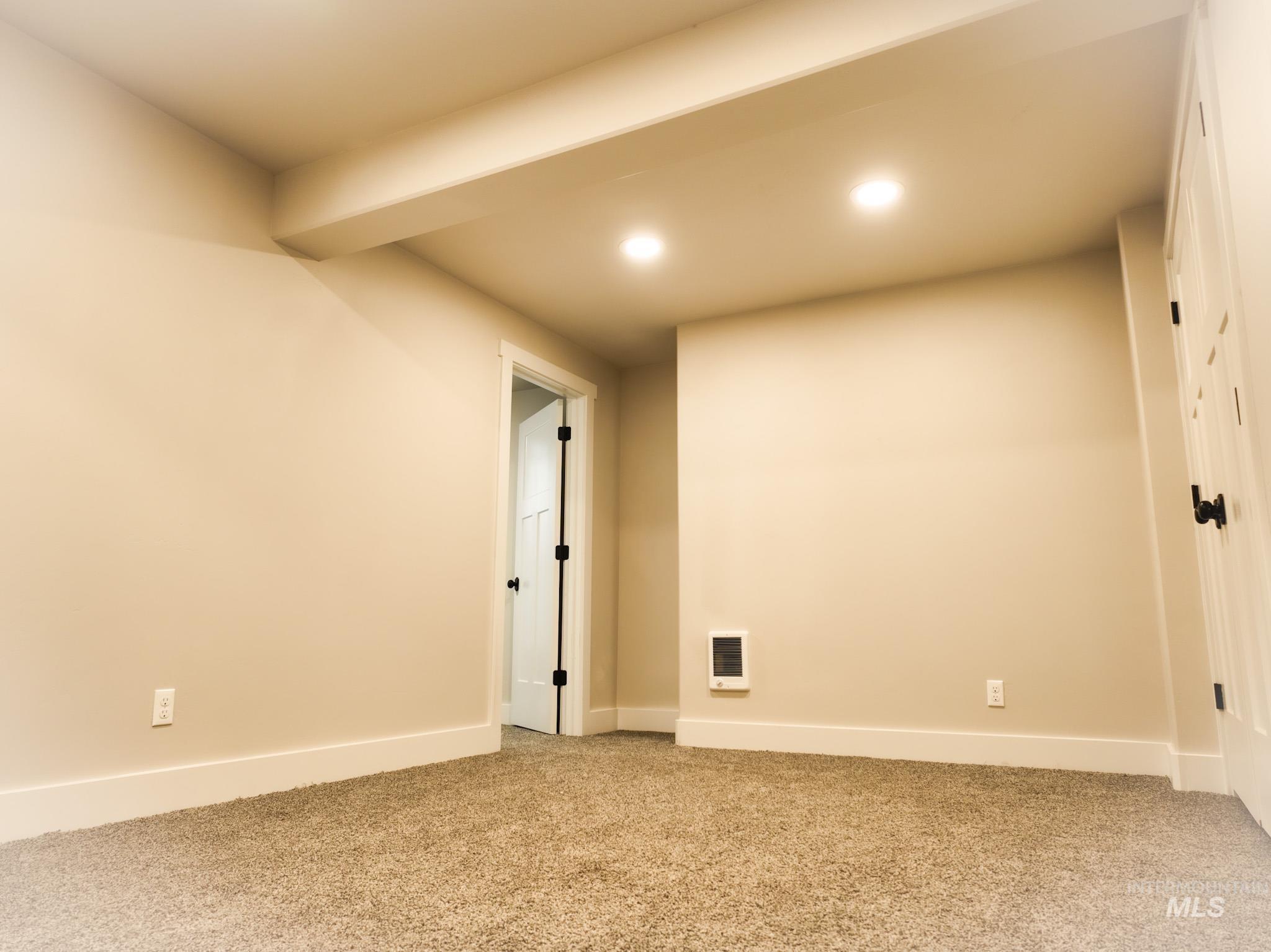 Basement featuring carpet, recessed lighting, and heating unit