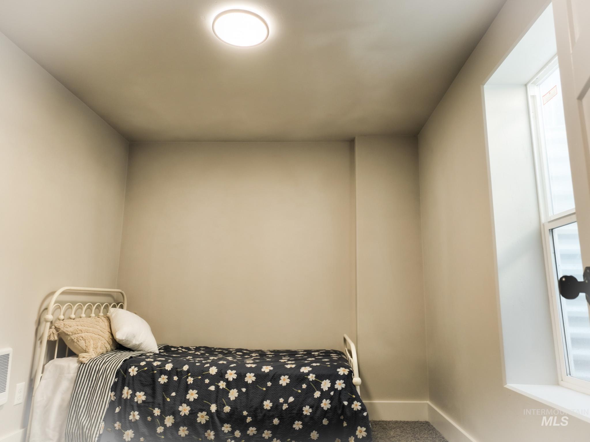 Carpeted bedroom with baseboards