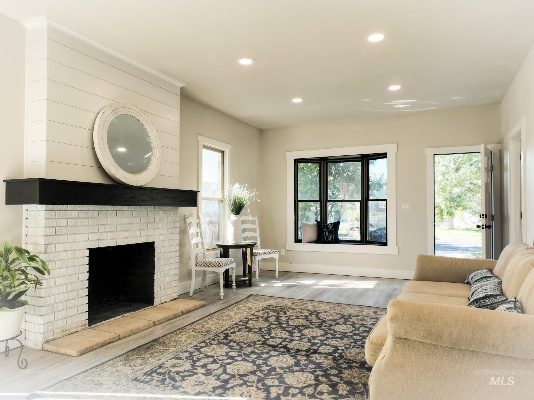 Living area featuring recessed lighting, wood finished floors, and a fireplace