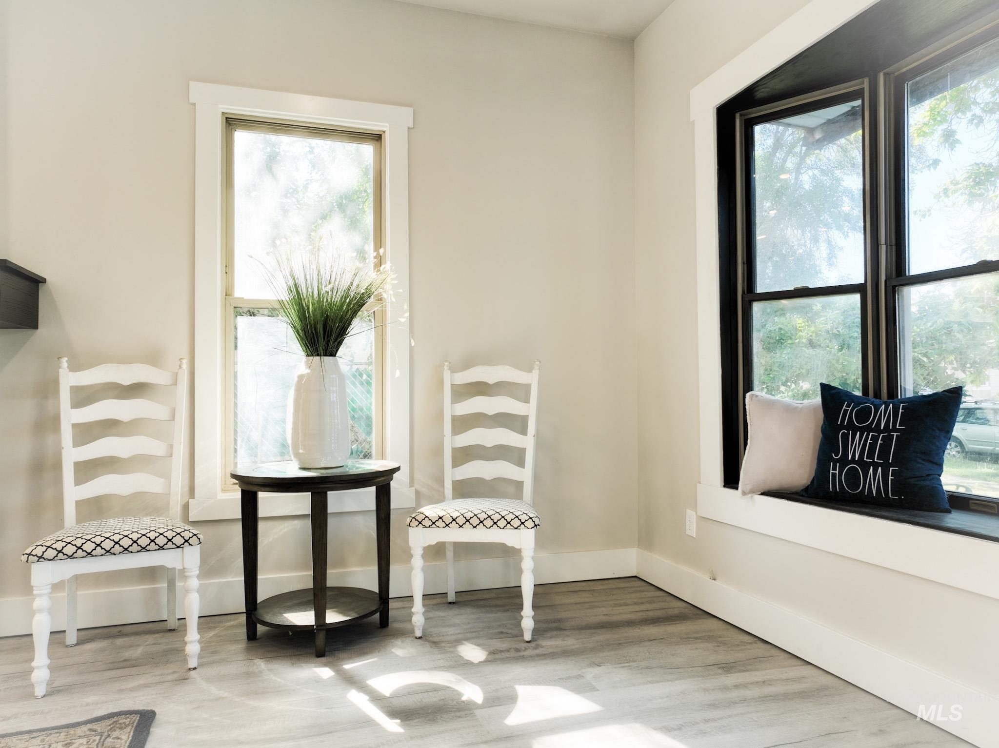 Sitting room featuring healthy amount of natural light and light wood-style floors