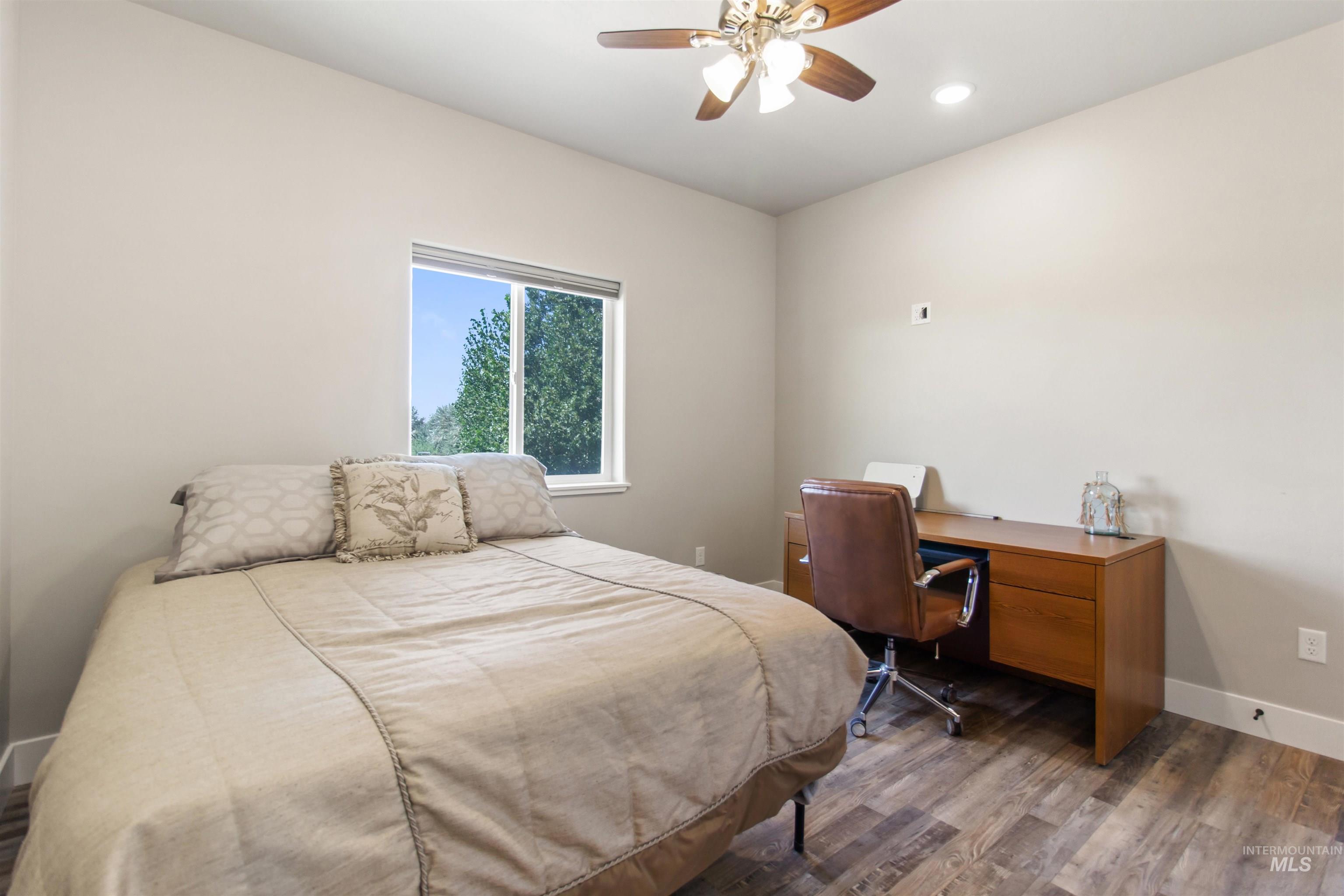 Bedroom featuring dark wood finished floors, ceiling fan, recessed lighting, and an office area