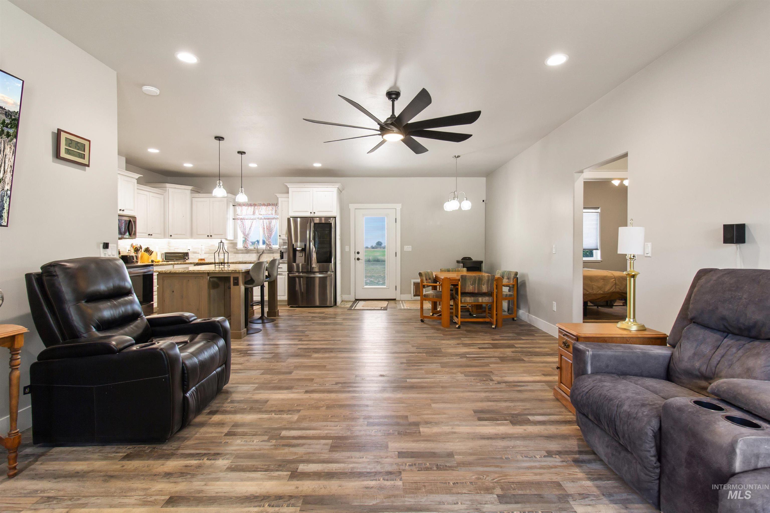 Living room featuring recessed lighting, dark wood finished floors, and ceiling fan