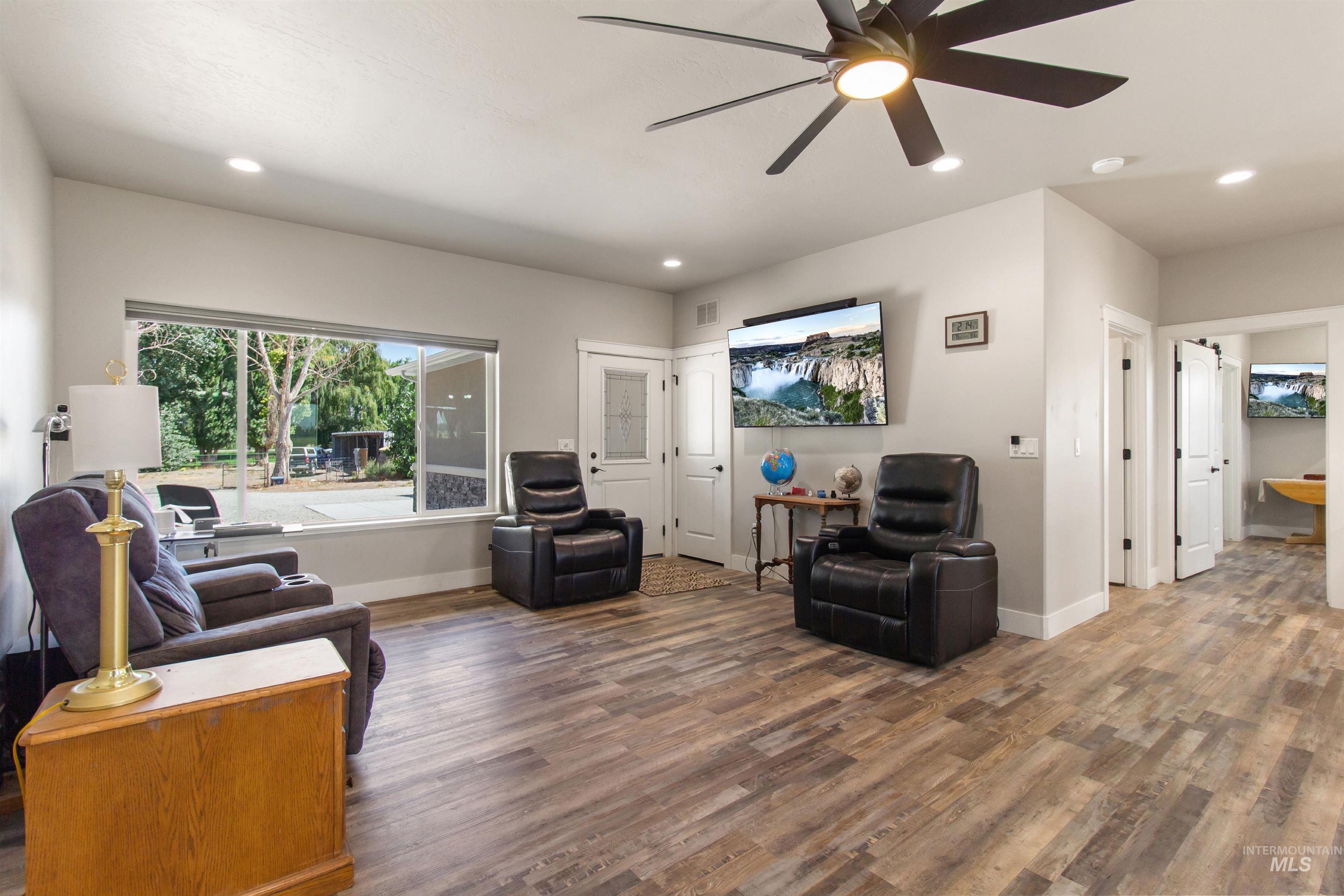 Living room featuring recessed lighting, a ceiling fan, and wood finished floors