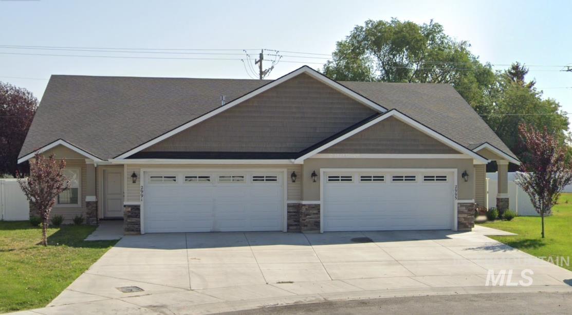 Craftsman-style home with stone siding, concrete driveway, and a garage