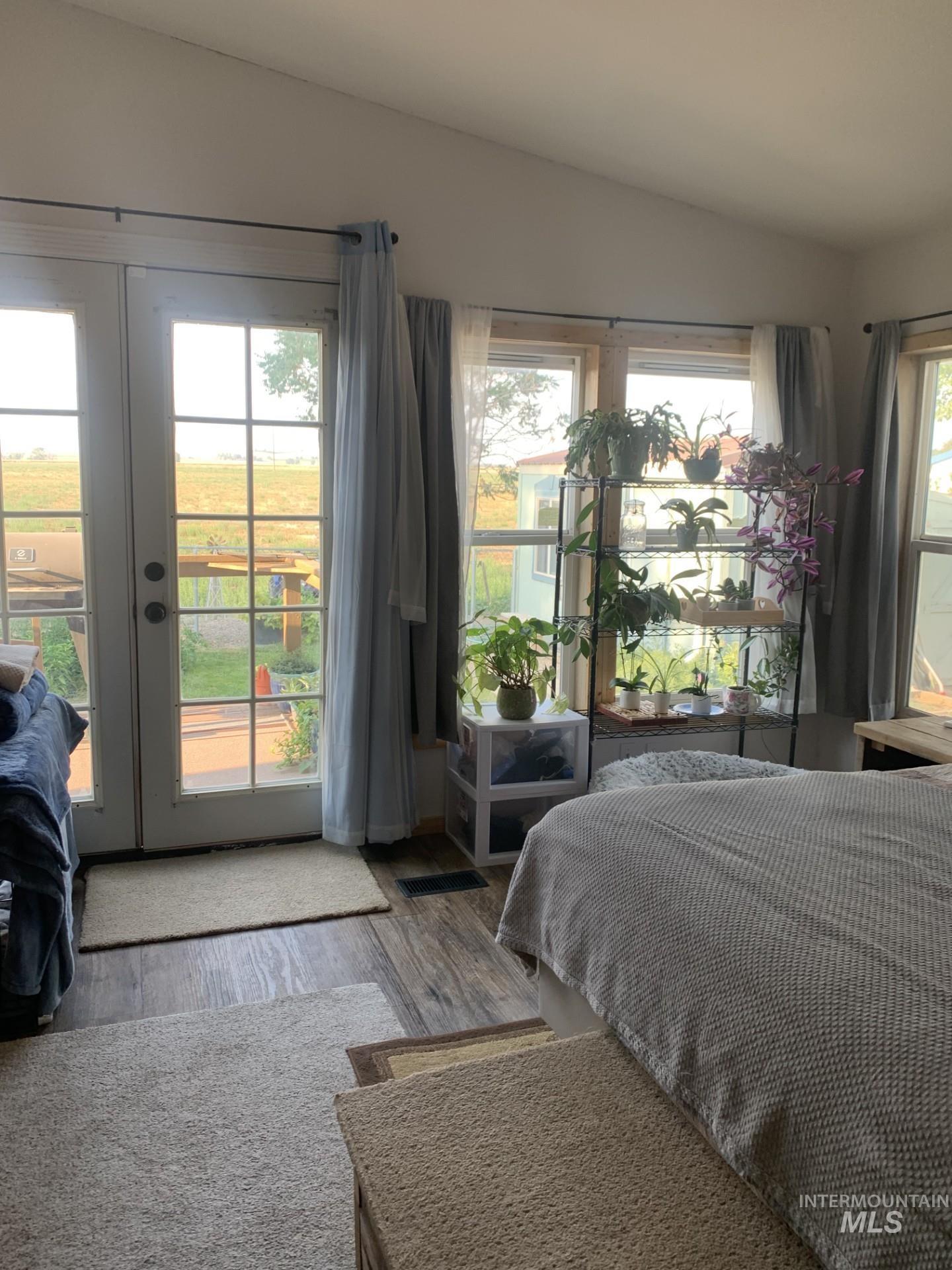 Bedroom featuring access to outside and wood finished floors