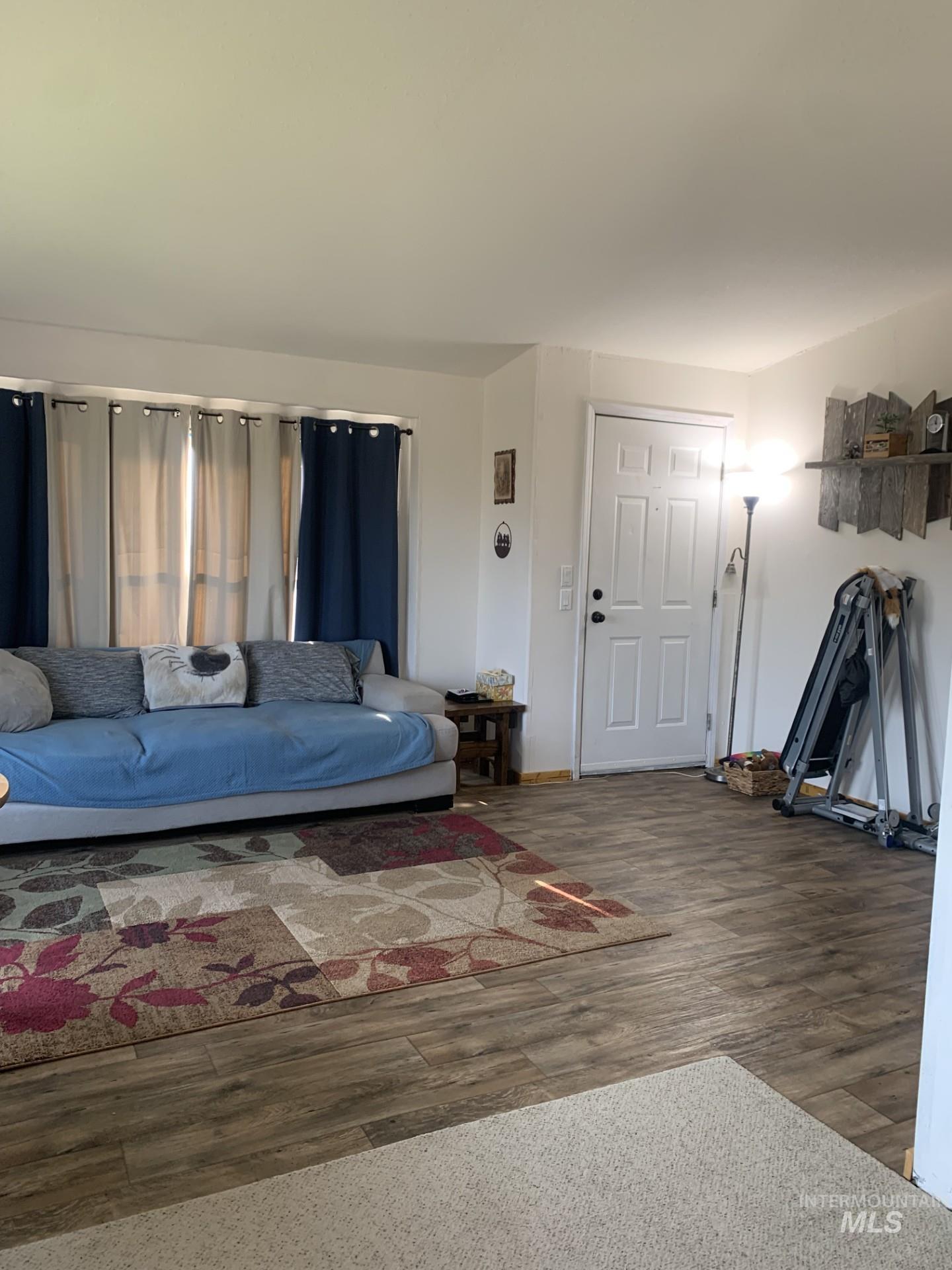 Living area featuring wood finished floors and baseboards